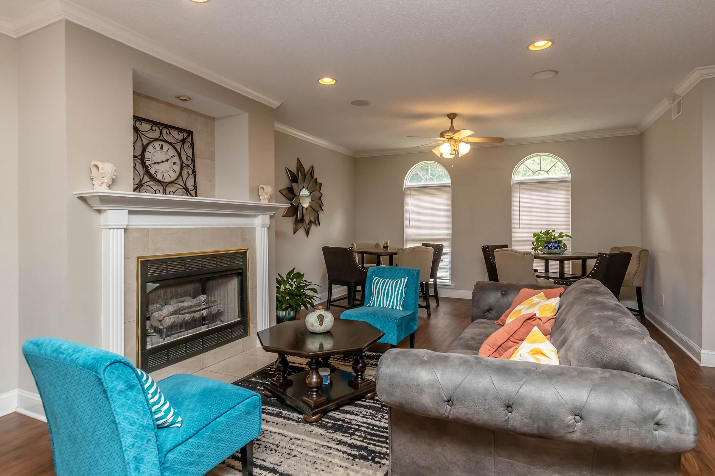 a living room filled with furniture and a fire place