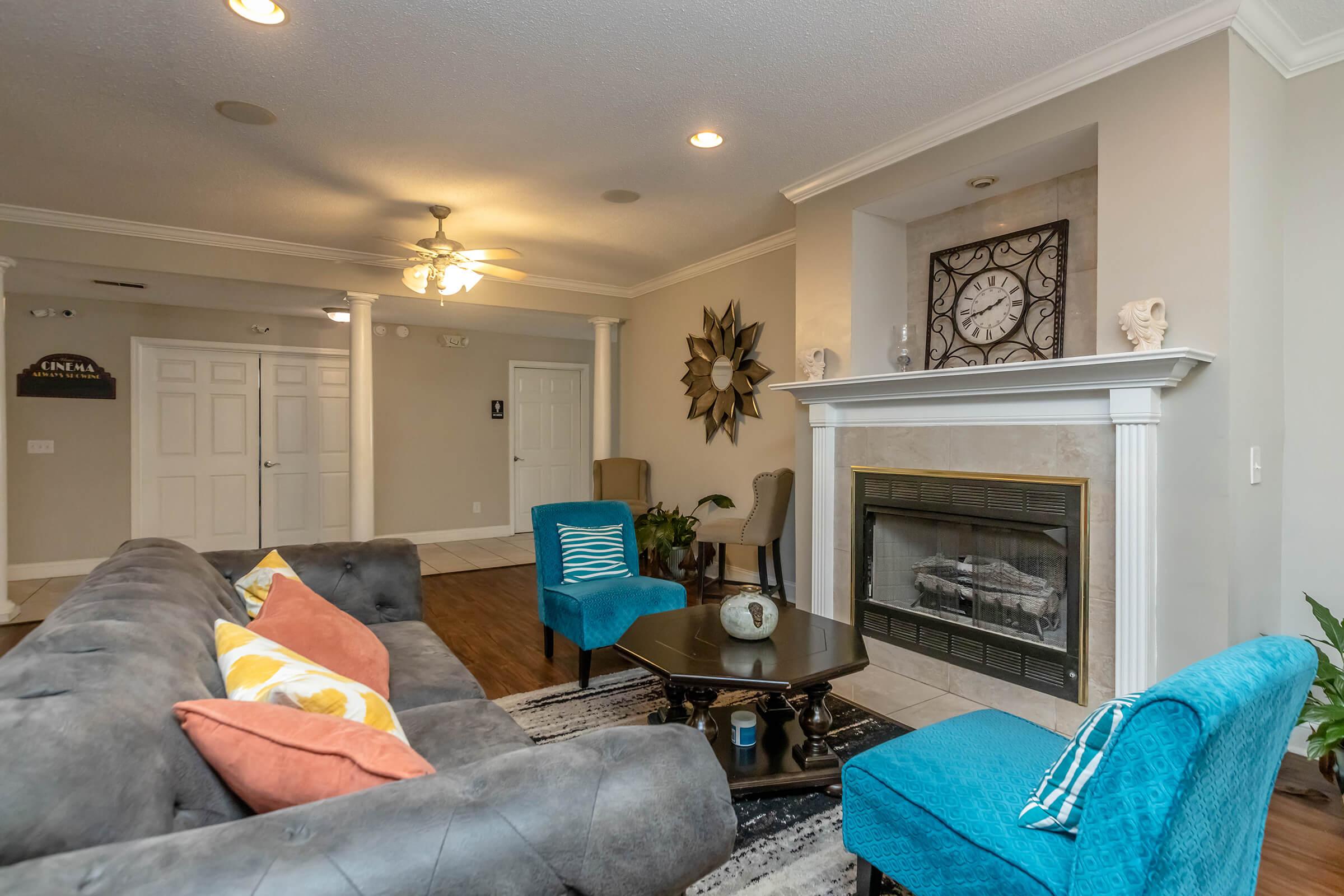 a living room filled with furniture and a fire place