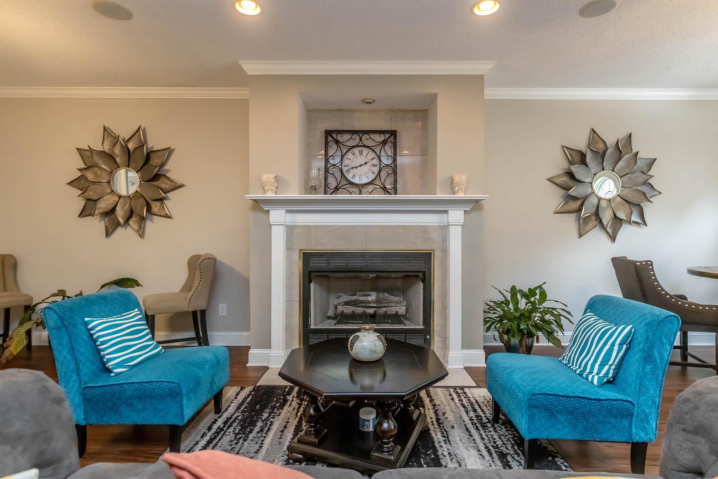 a living room filled with furniture and vase of flowers on a table