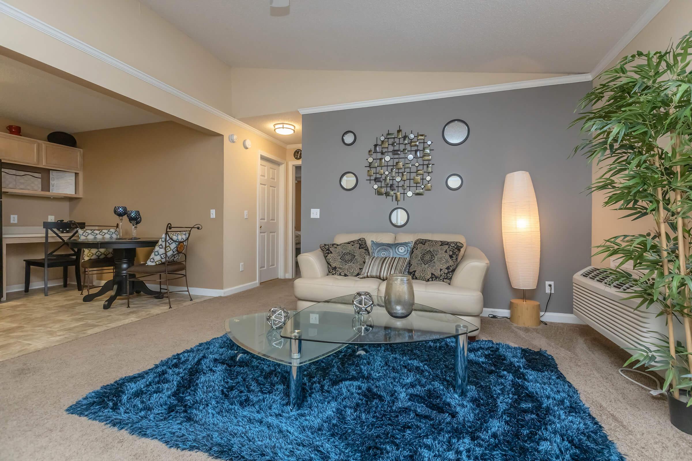 a living room filled with furniture and a rug