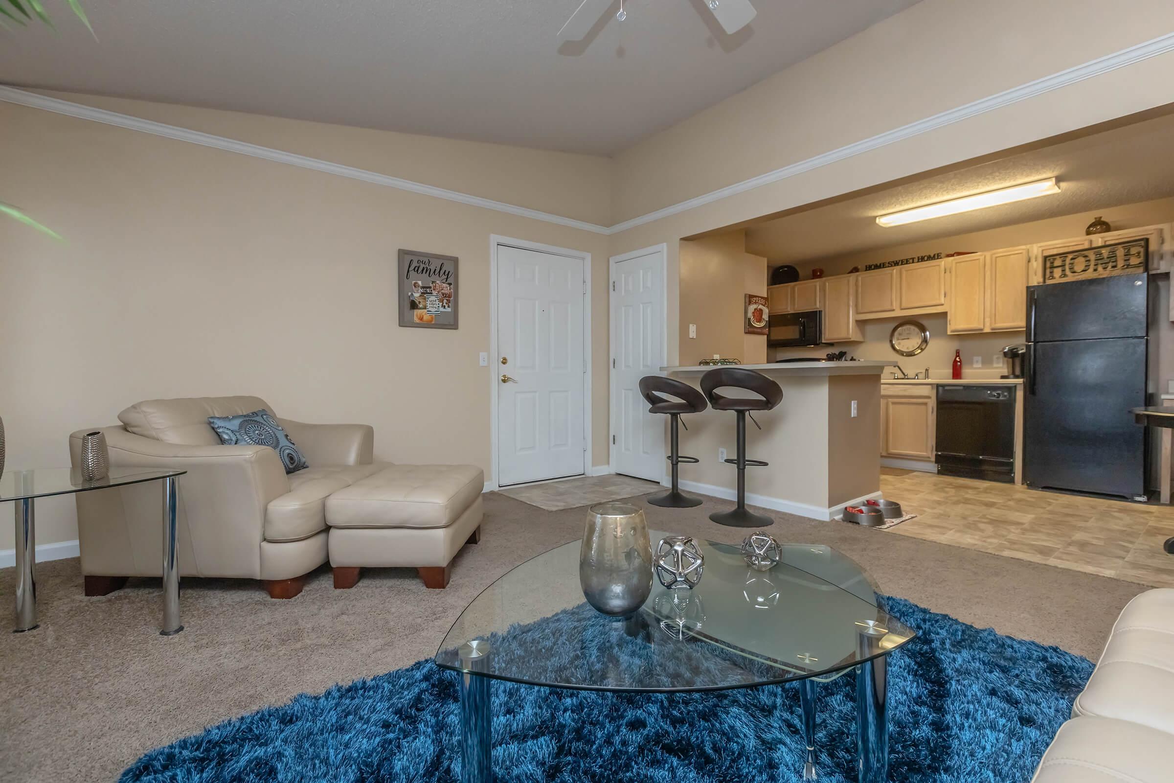 a living room filled with furniture and a sink