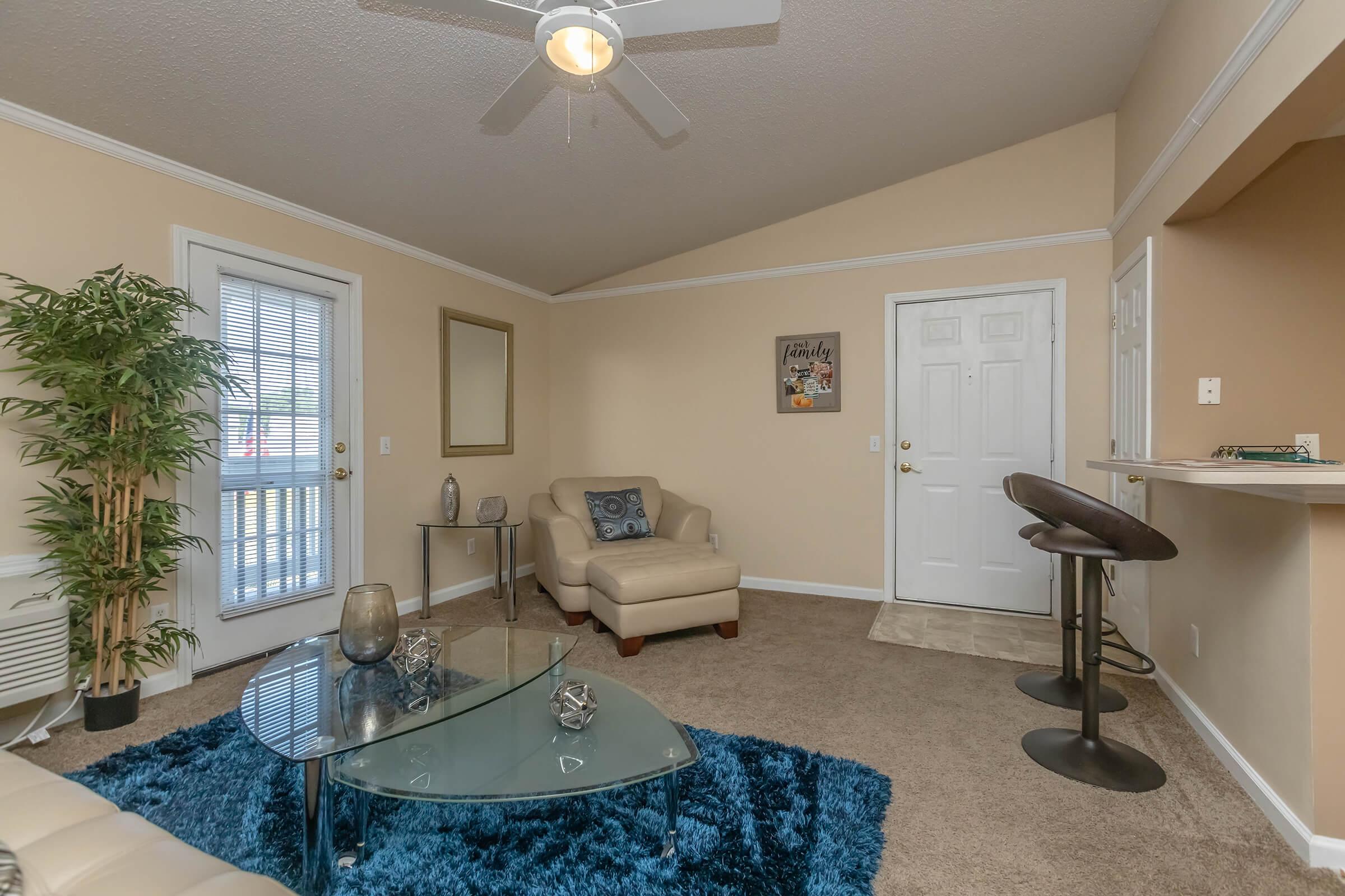 a living room filled with furniture and a flat screen tv