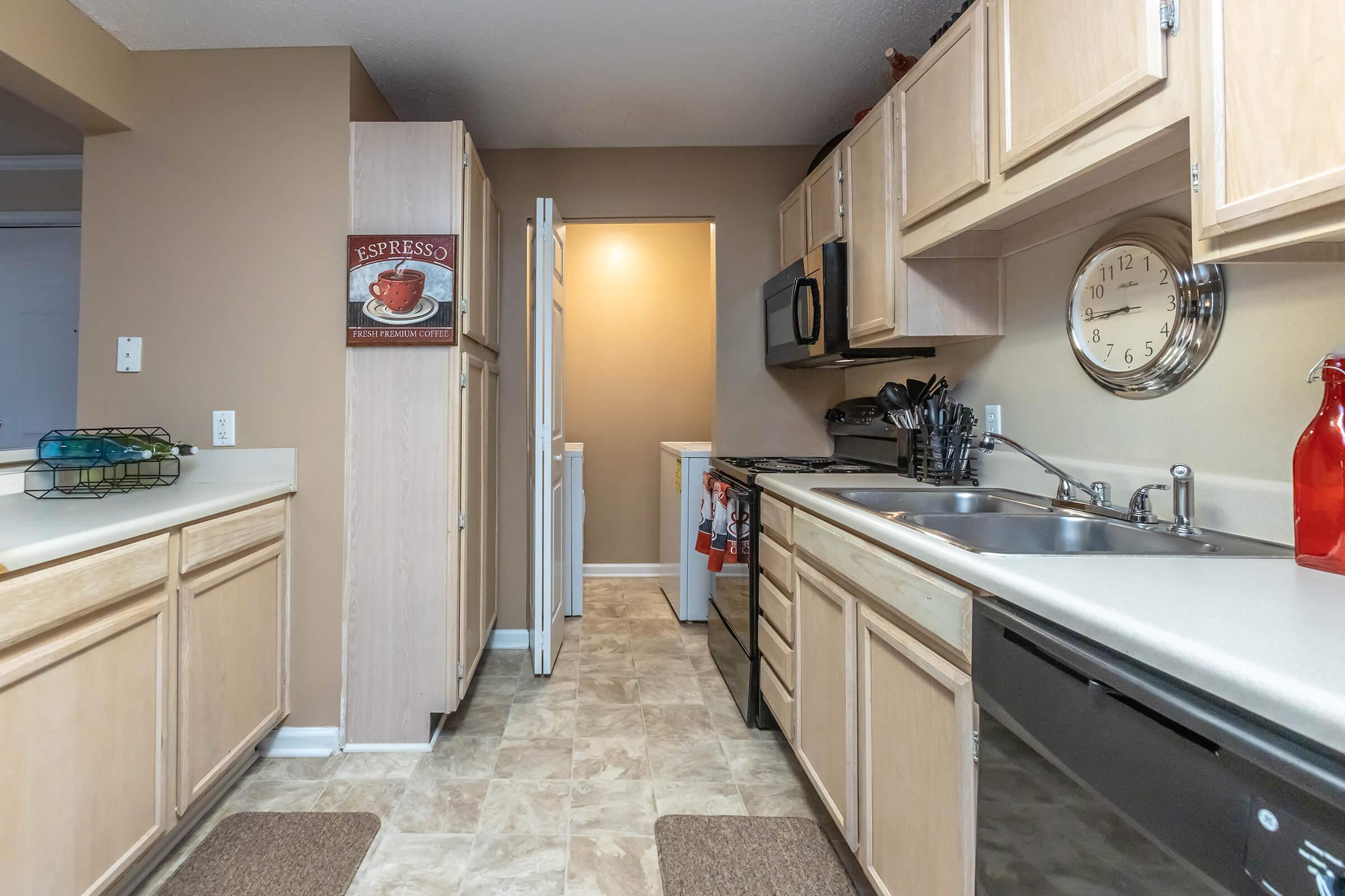 a kitchen with a stove sink and refrigerator