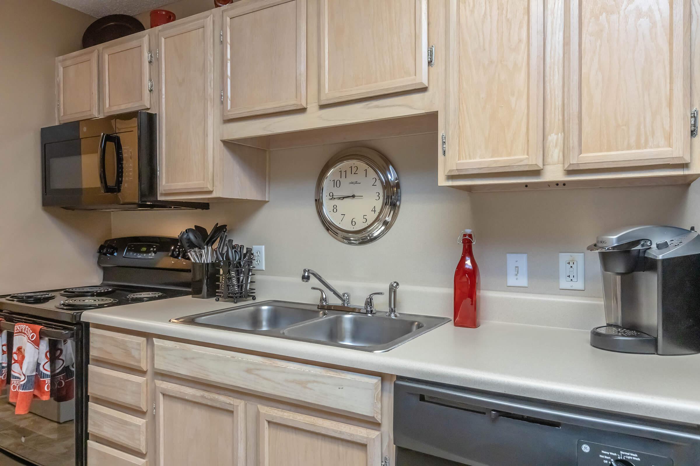 a kitchen with a stove a sink and a microwave