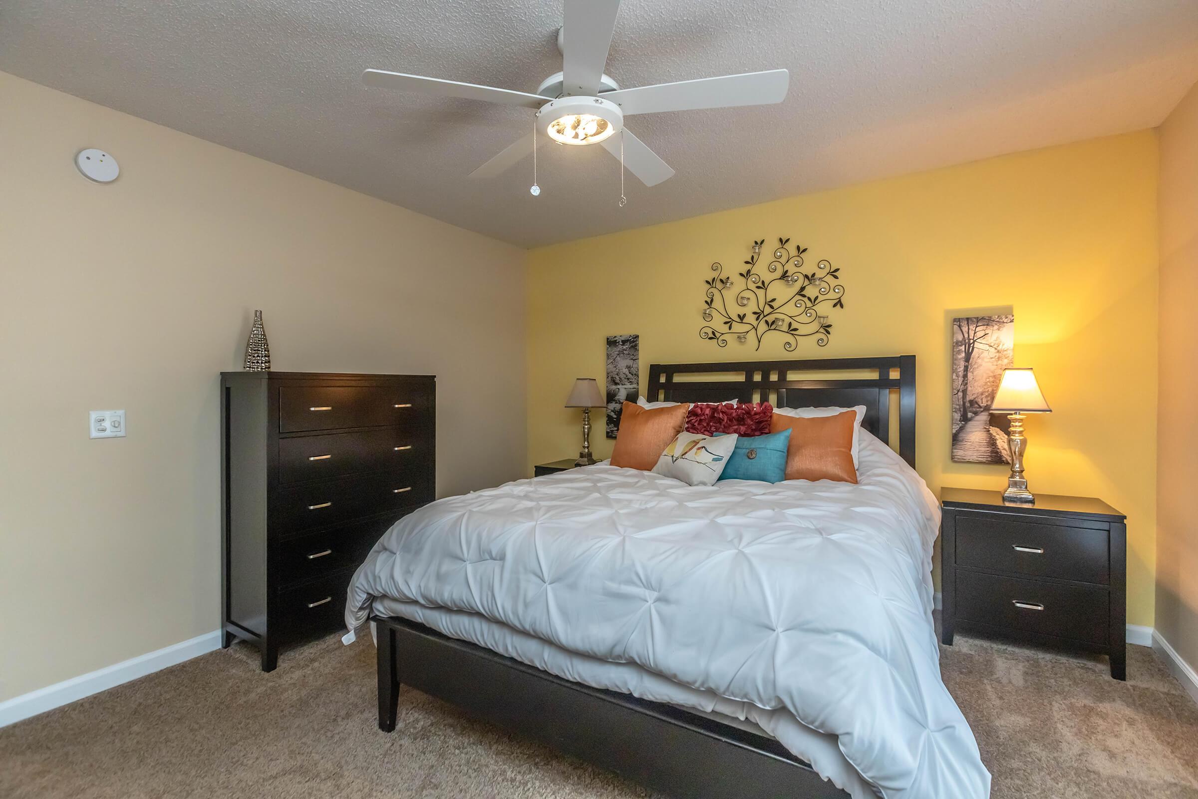 a bedroom with a bed and desk in a room