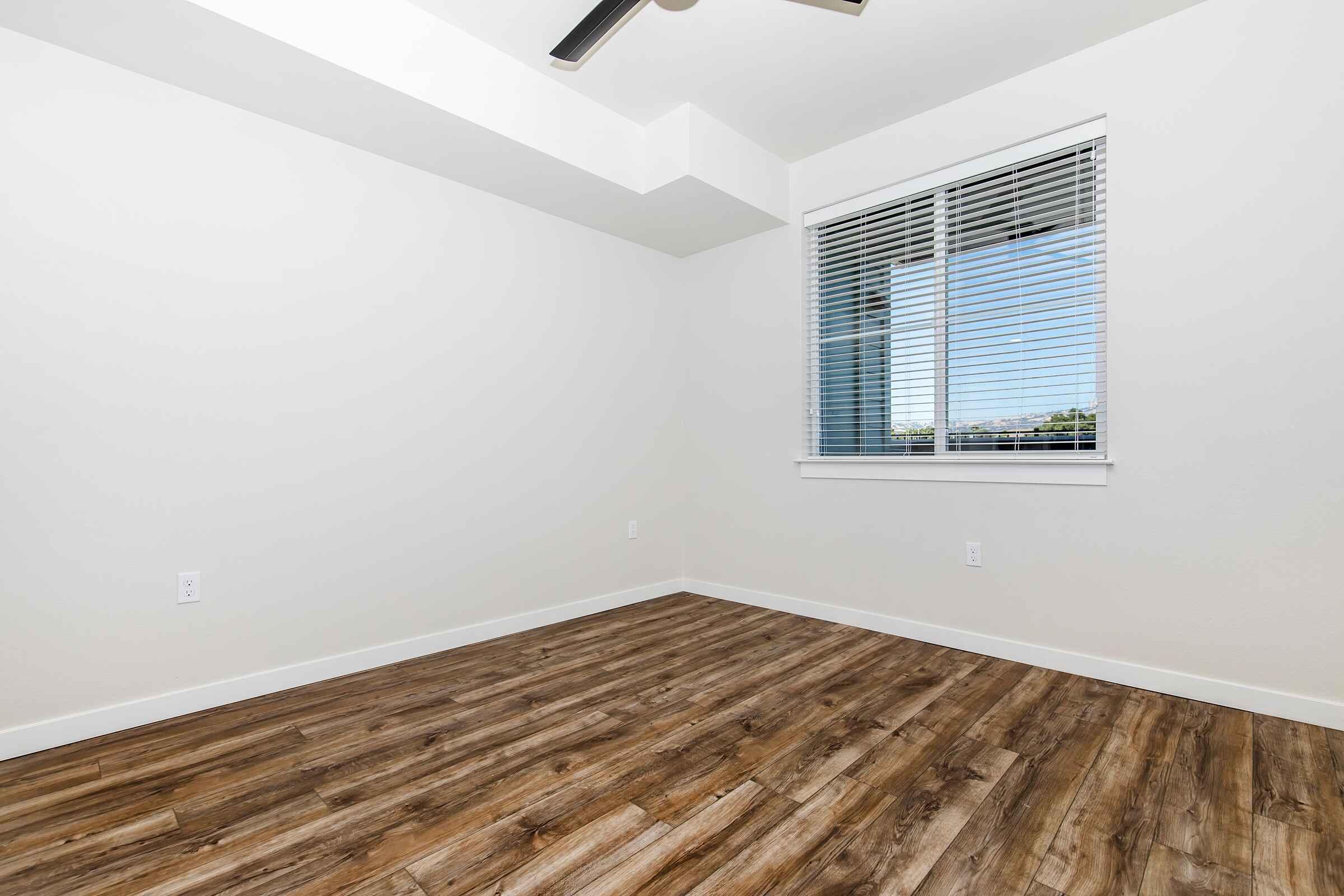 a bedroom with a building in the background