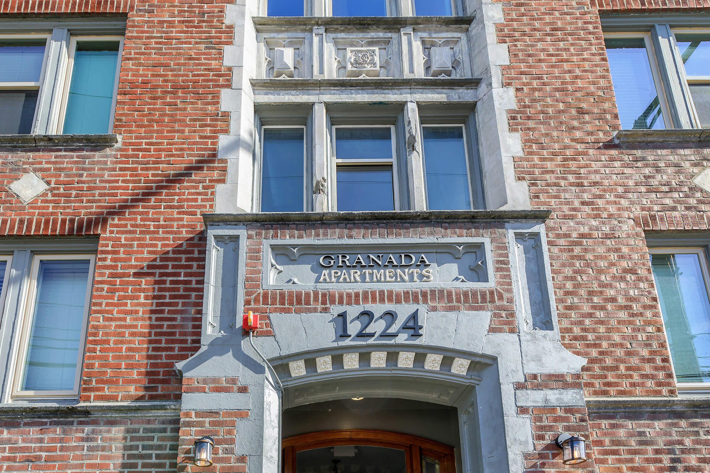 a sign in front of a brick building