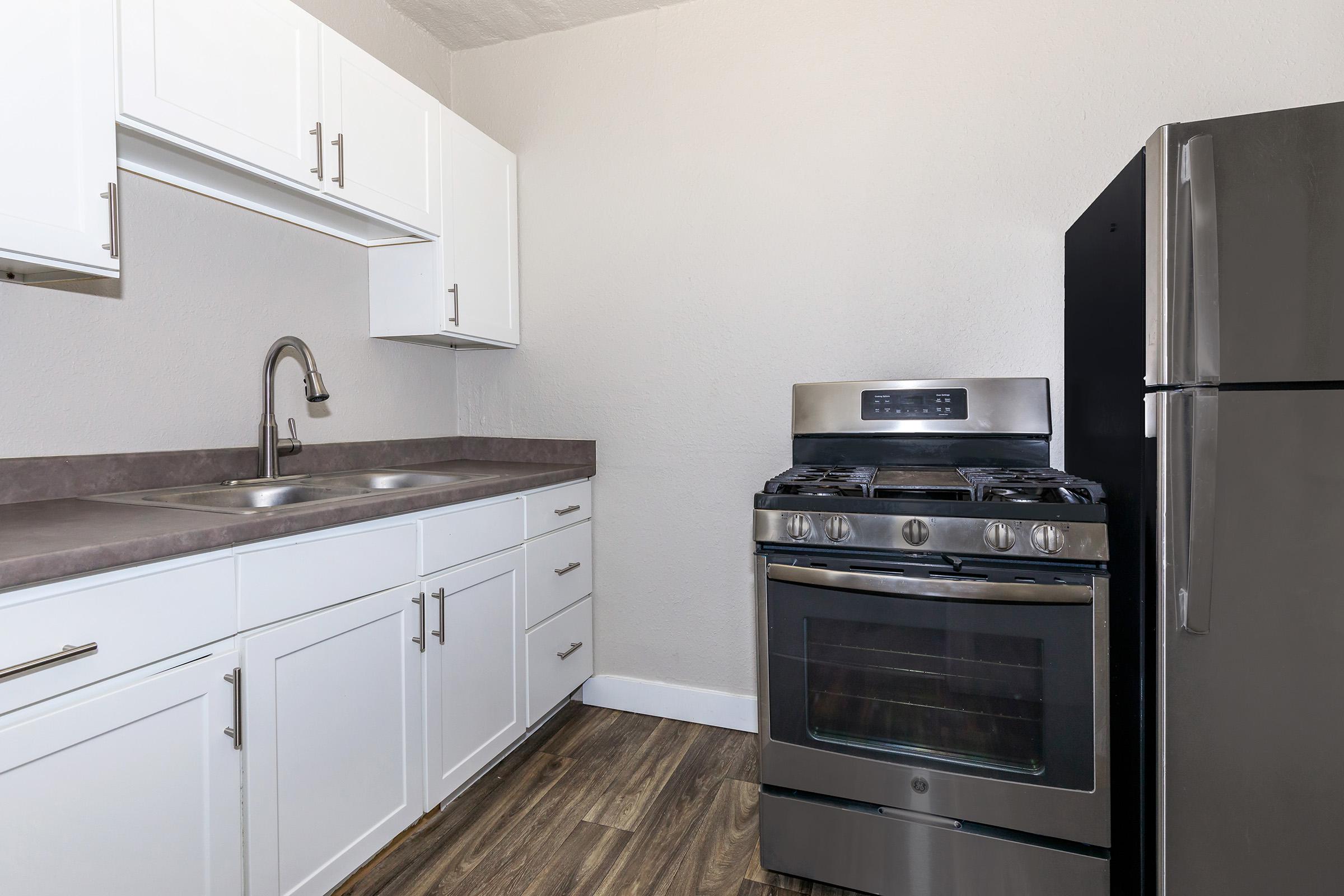 a kitchen with a stove and a refrigerator