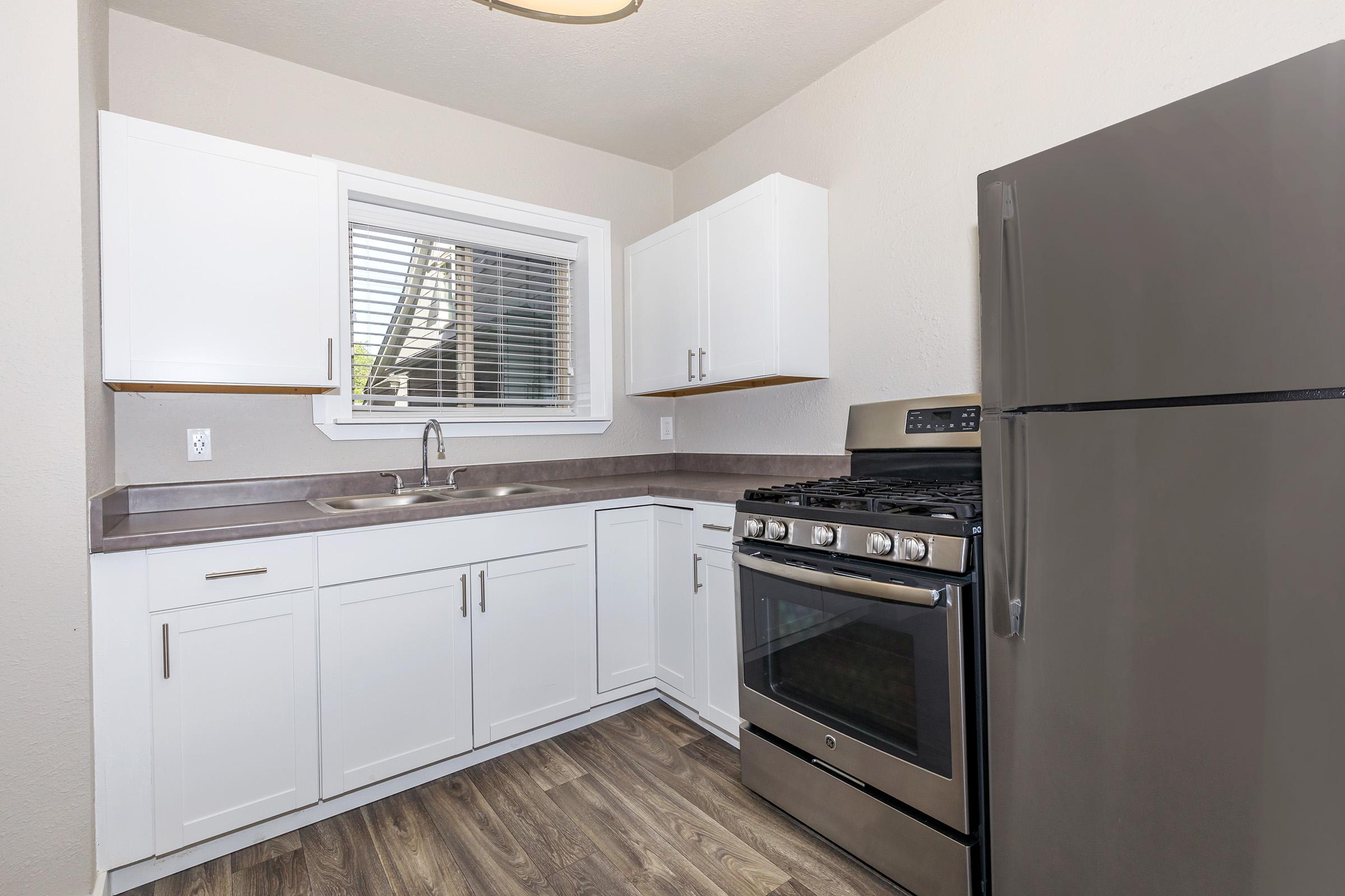 a kitchen with a stove and a refrigerator