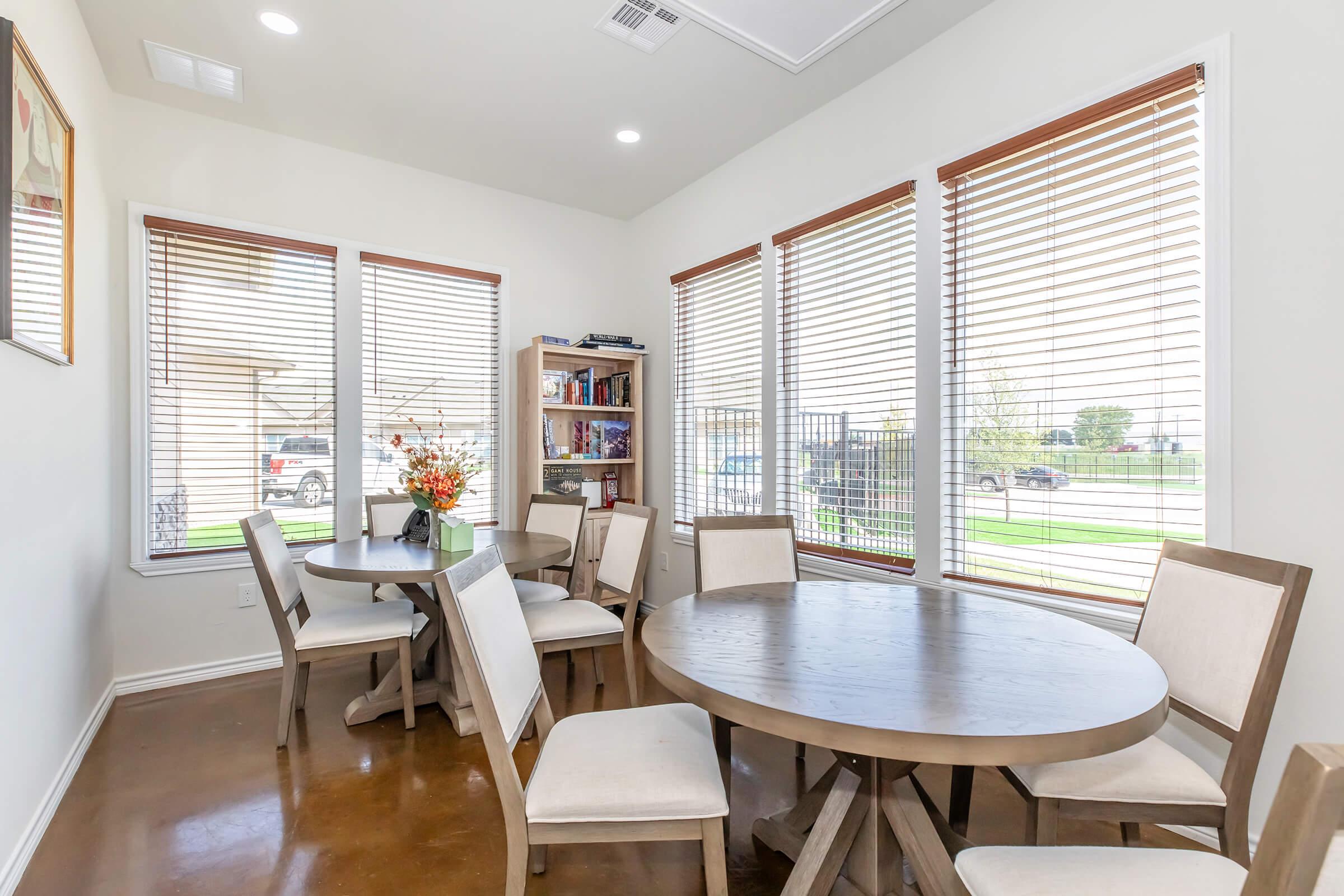 a dining room table in front of a window