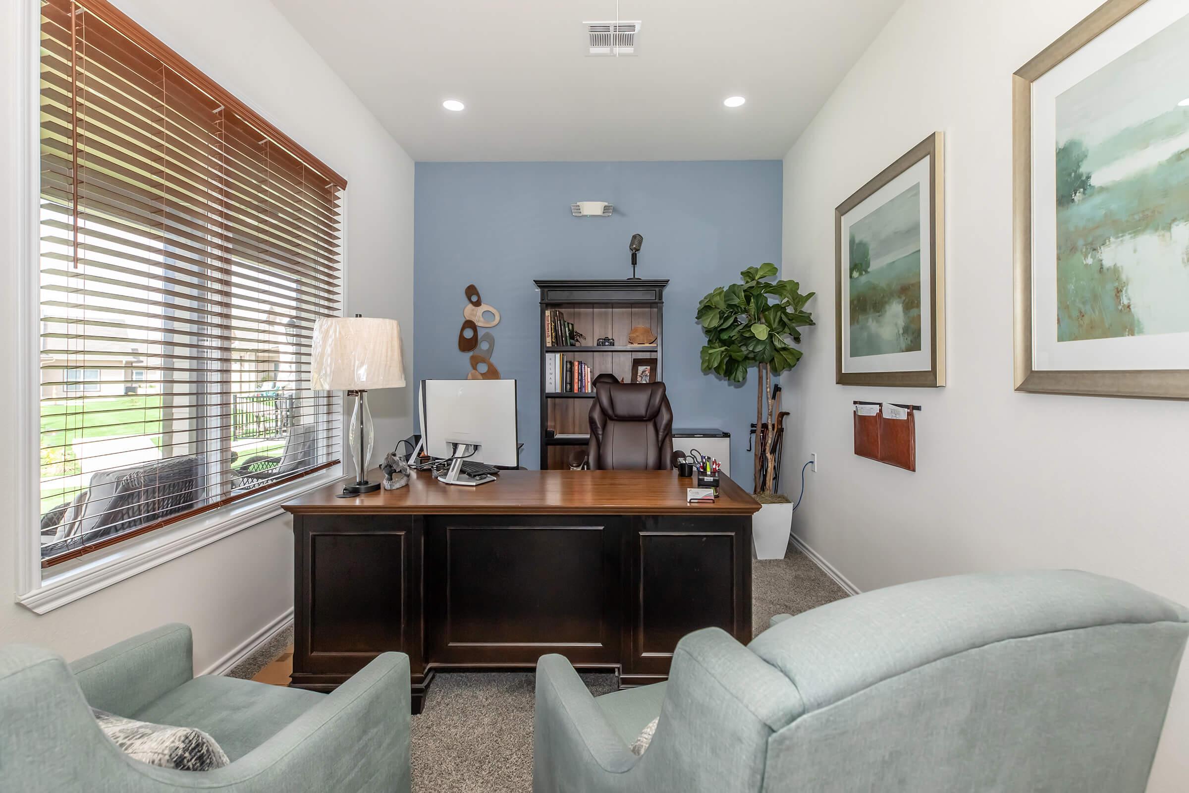 a living room filled with furniture and a large window