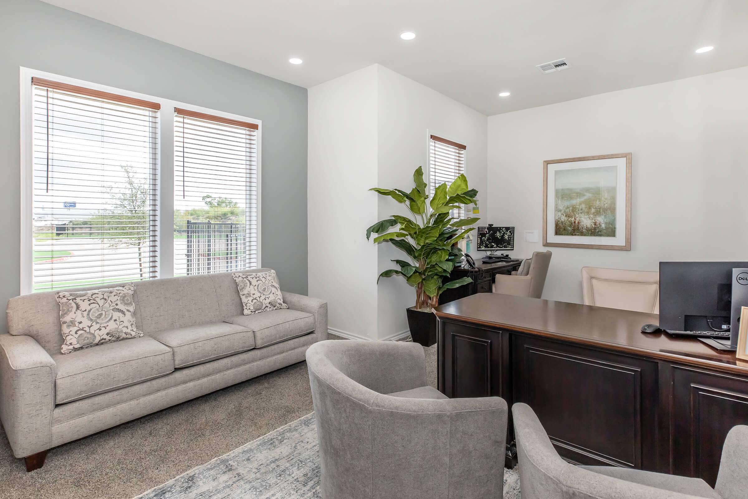 a living room filled with furniture and a large window