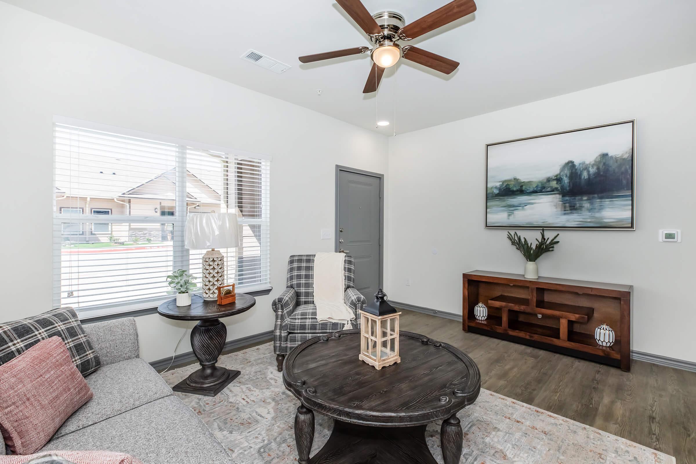 a living room filled with furniture and a window