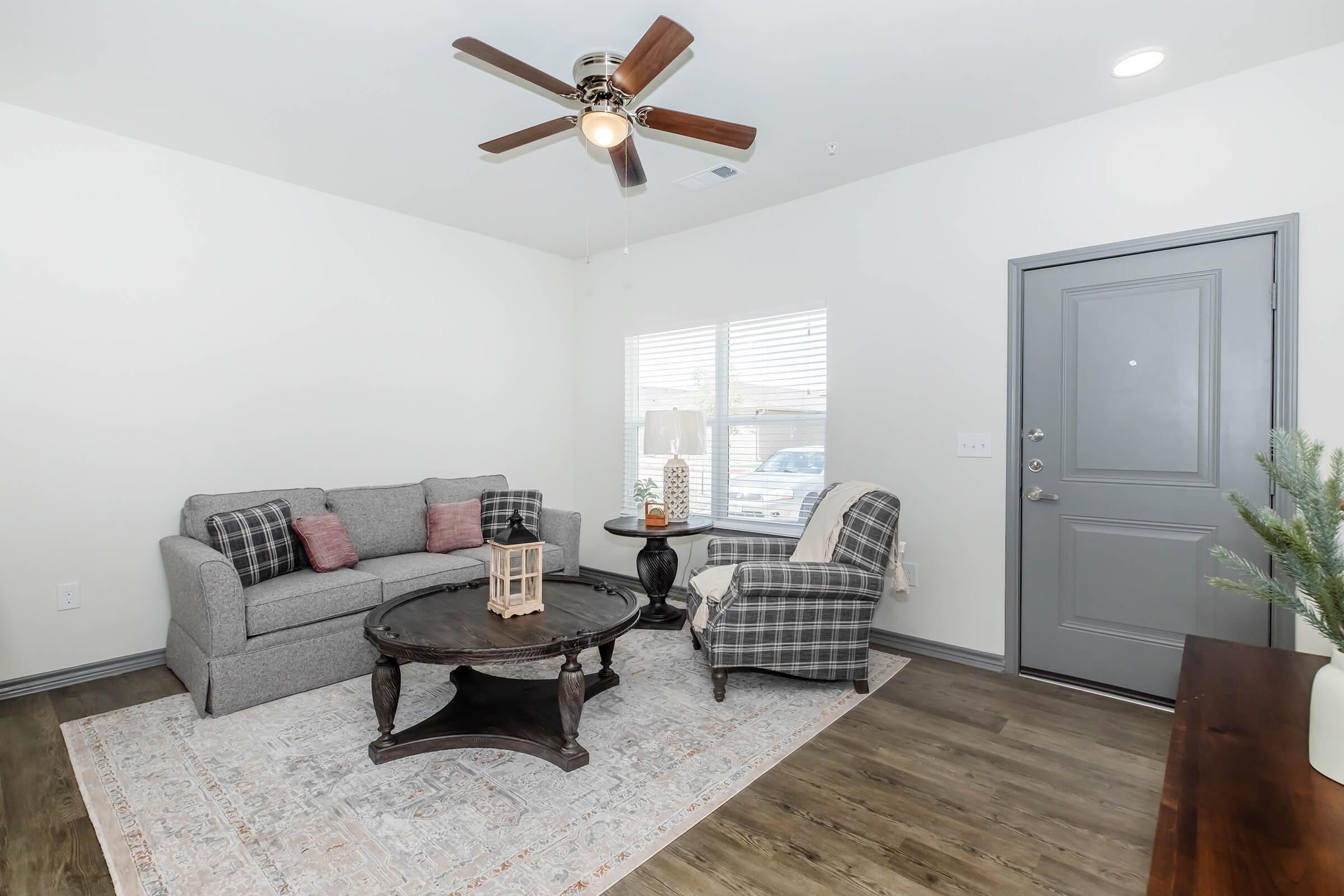 a living room filled with furniture and a large window