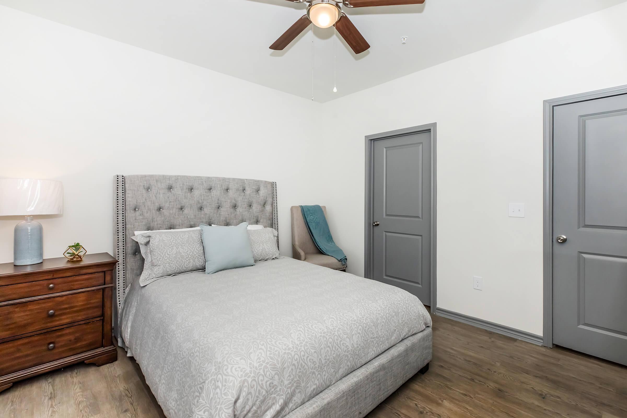 a bedroom with a bed and desk in a room