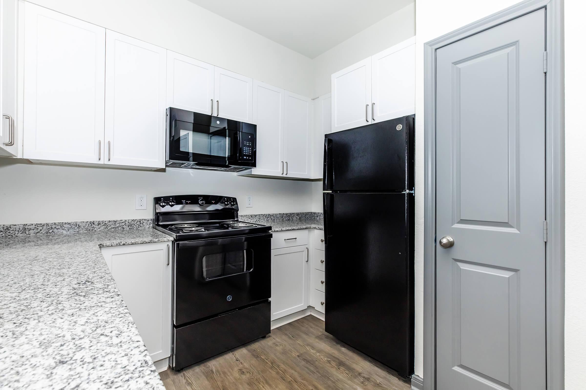 a kitchen with a stove and a refrigerator