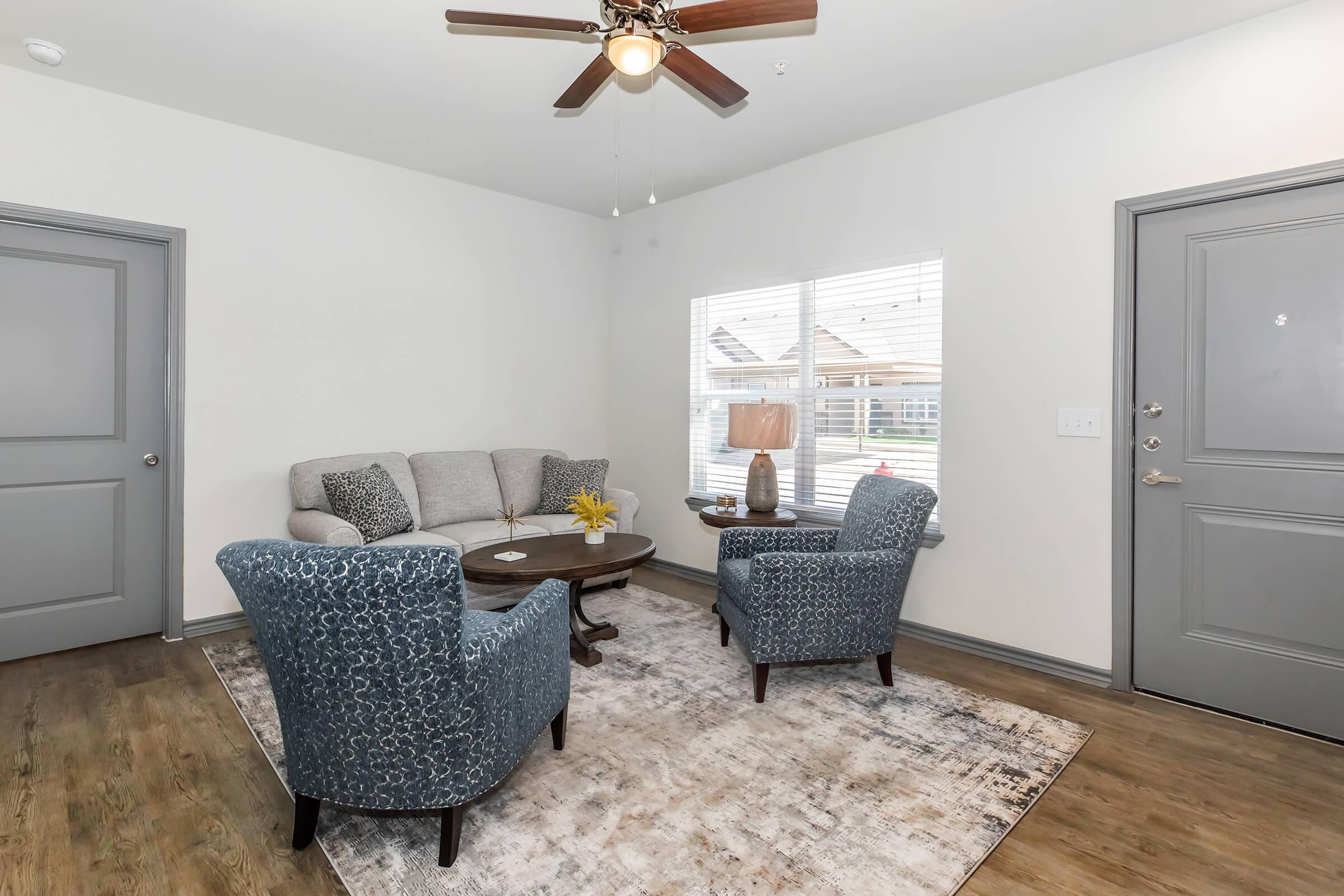 a living room filled with furniture and a rug