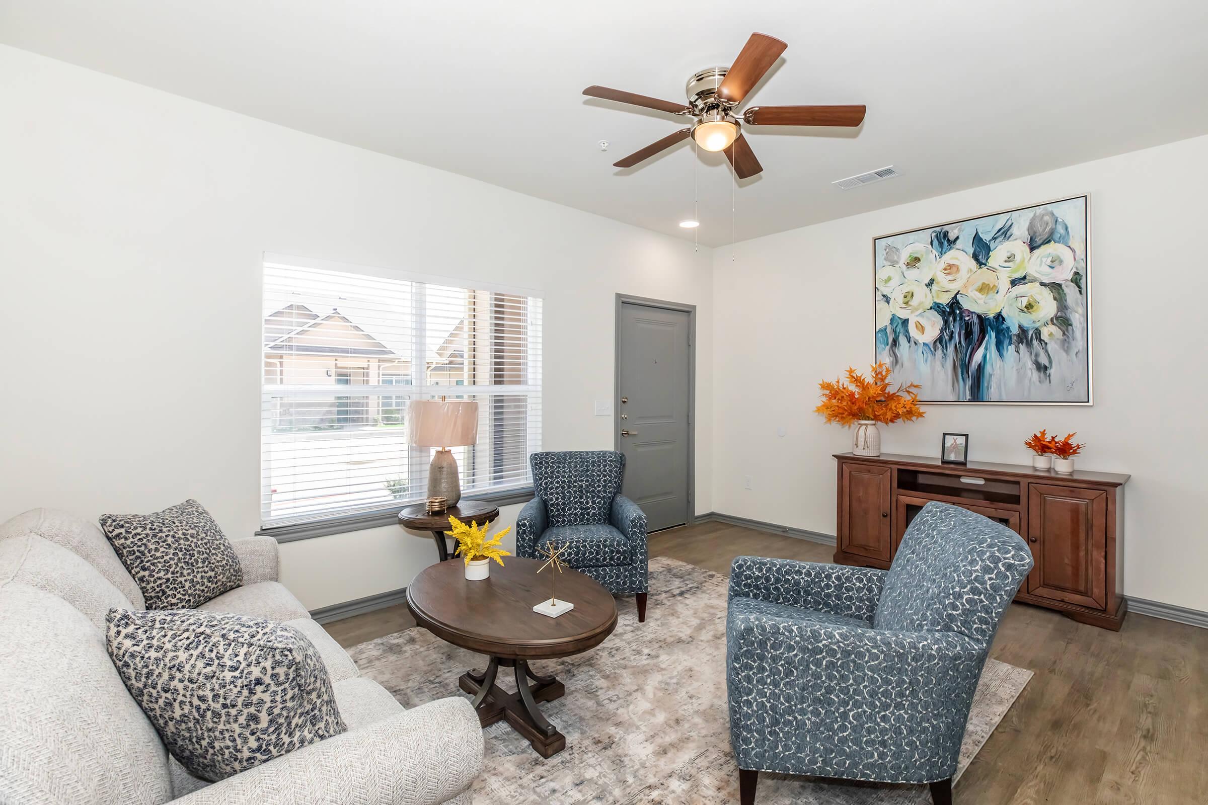 a living room filled with furniture and a large window