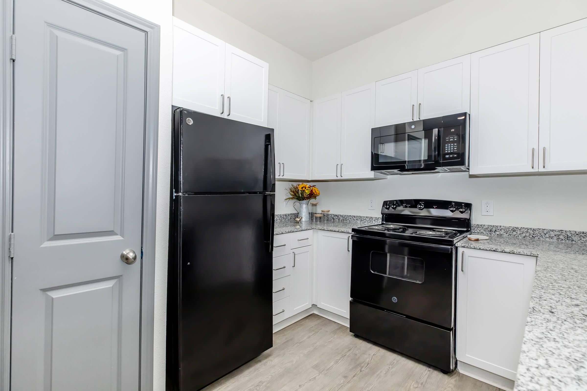 a kitchen with a sink and a refrigerator