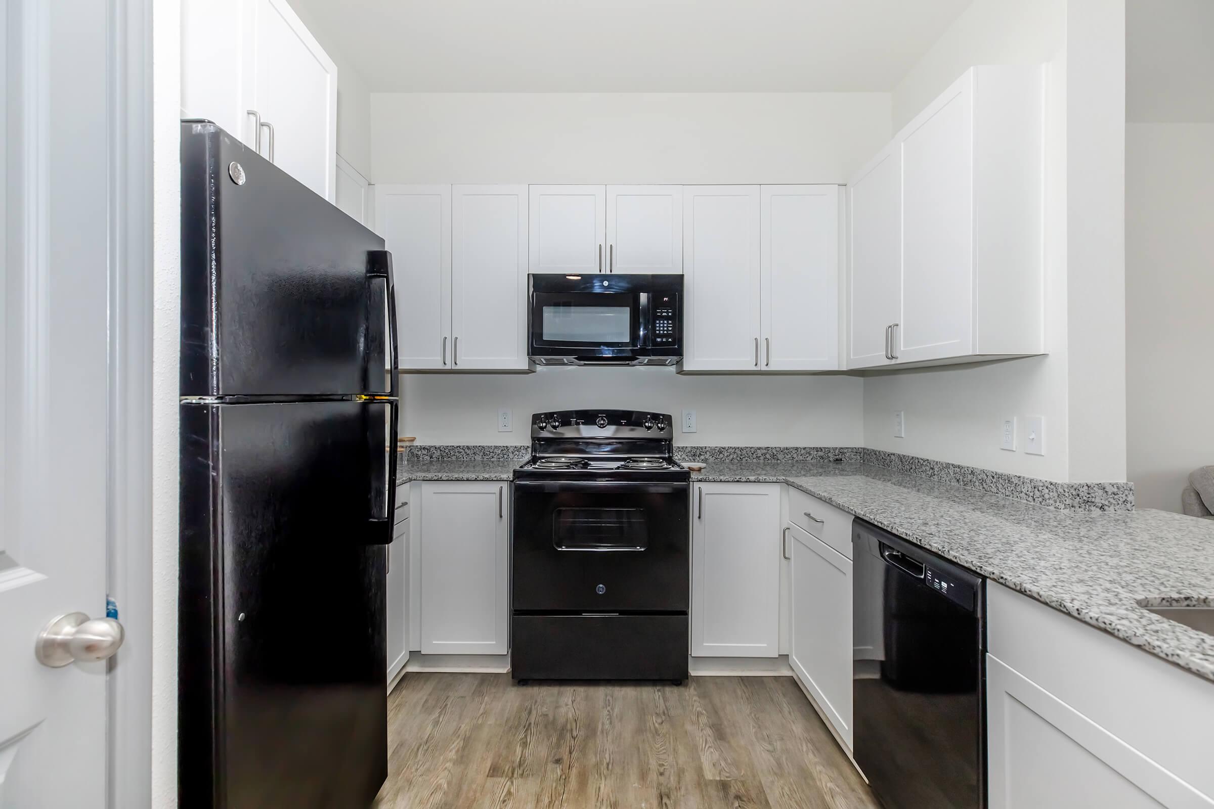 a kitchen with a stove and a refrigerator