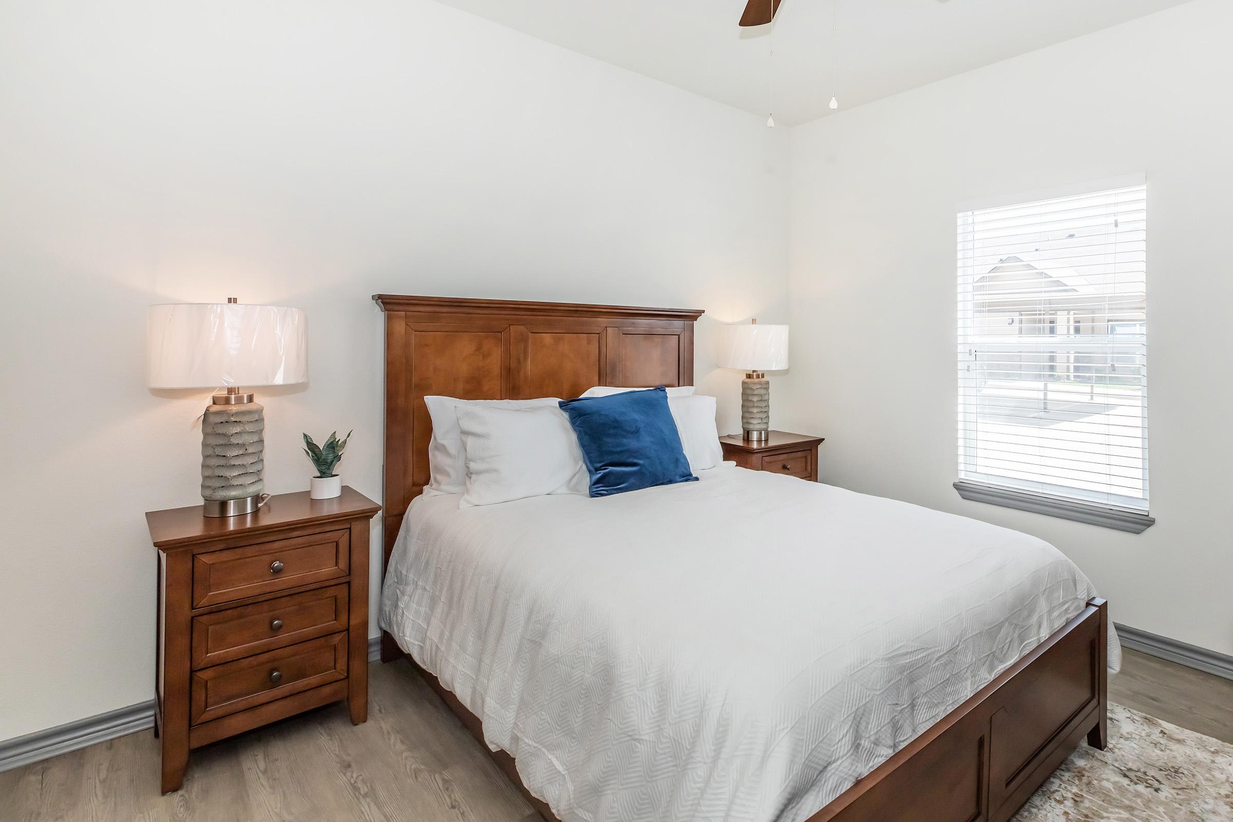 a bedroom with a bed and desk in a room