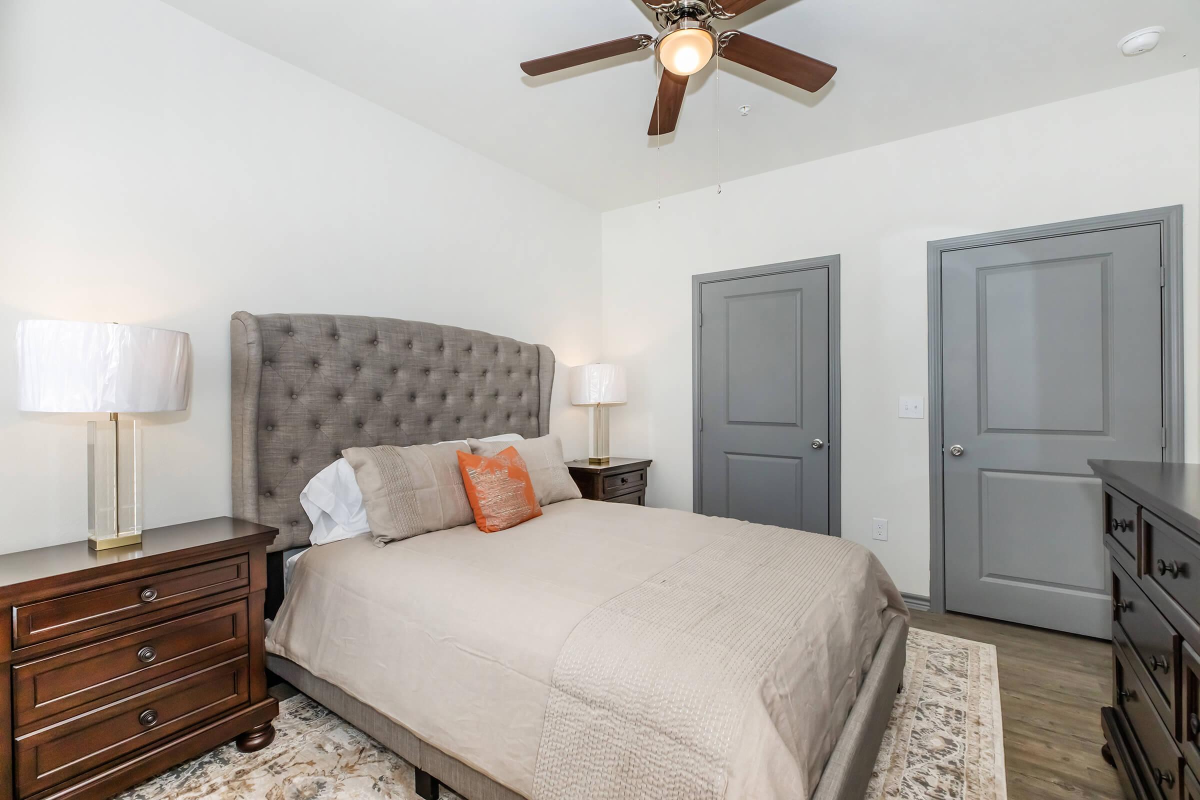 a bedroom with a bed and desk in a room