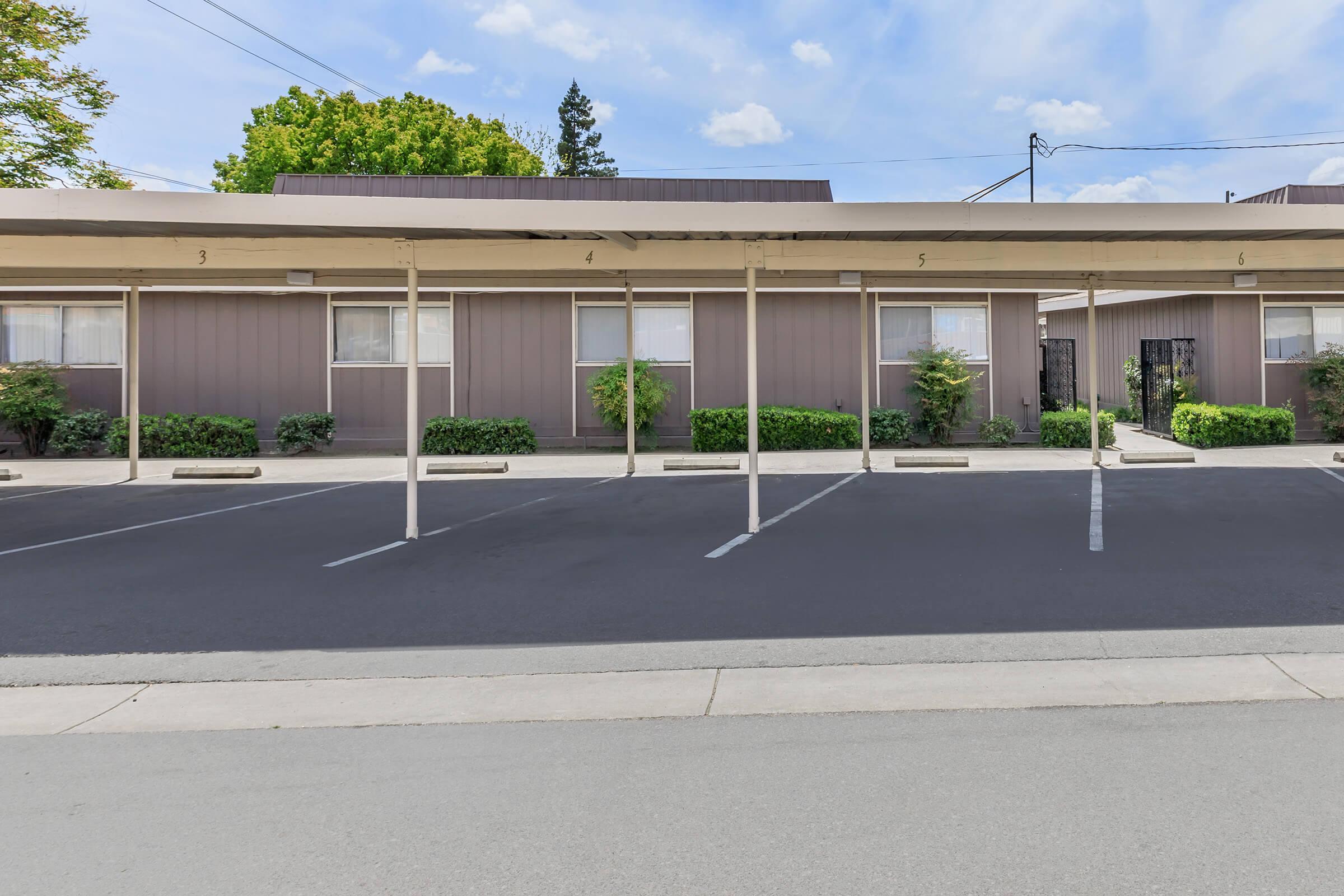 an empty parking lot in front of a building