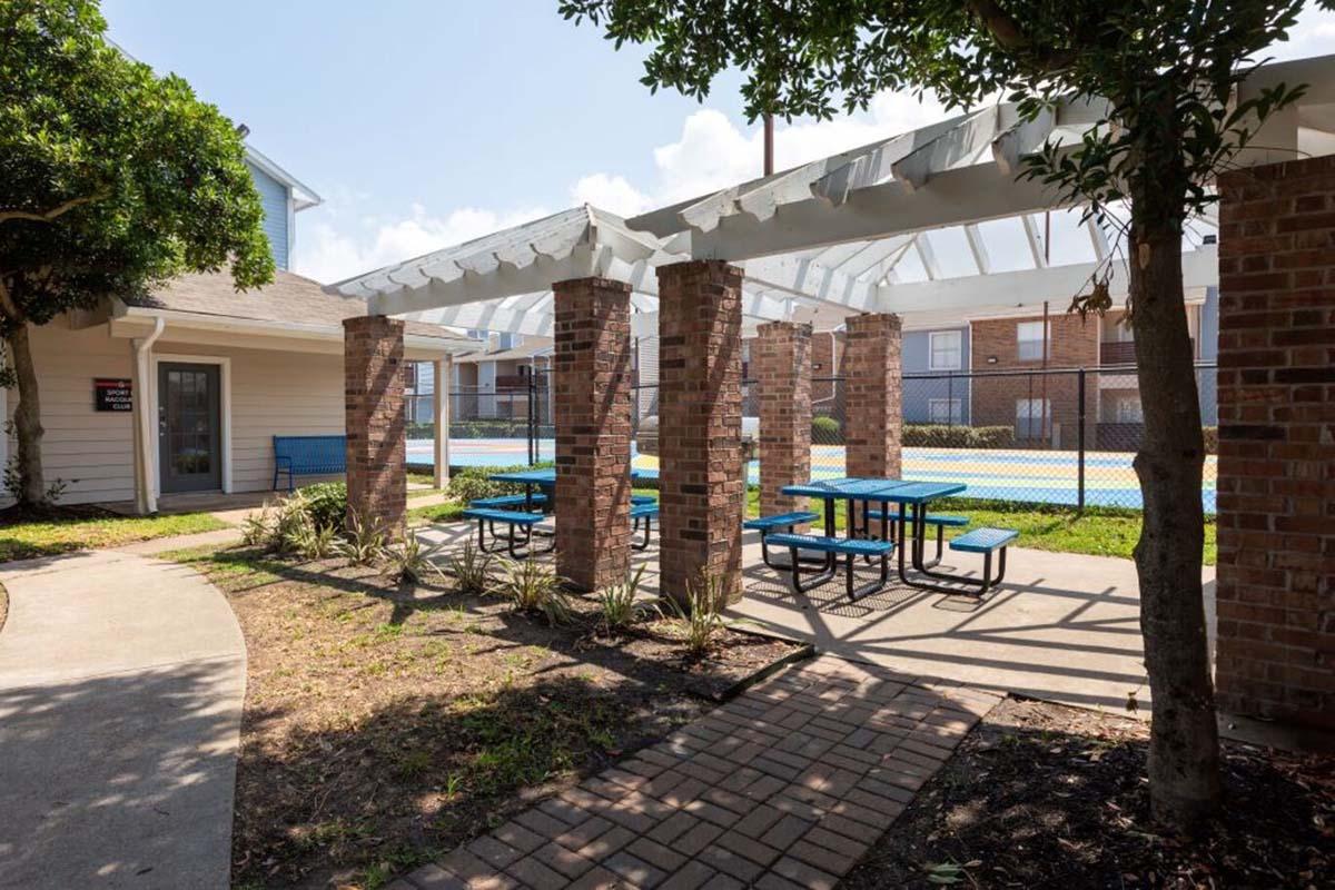 a bench in front of a brick building