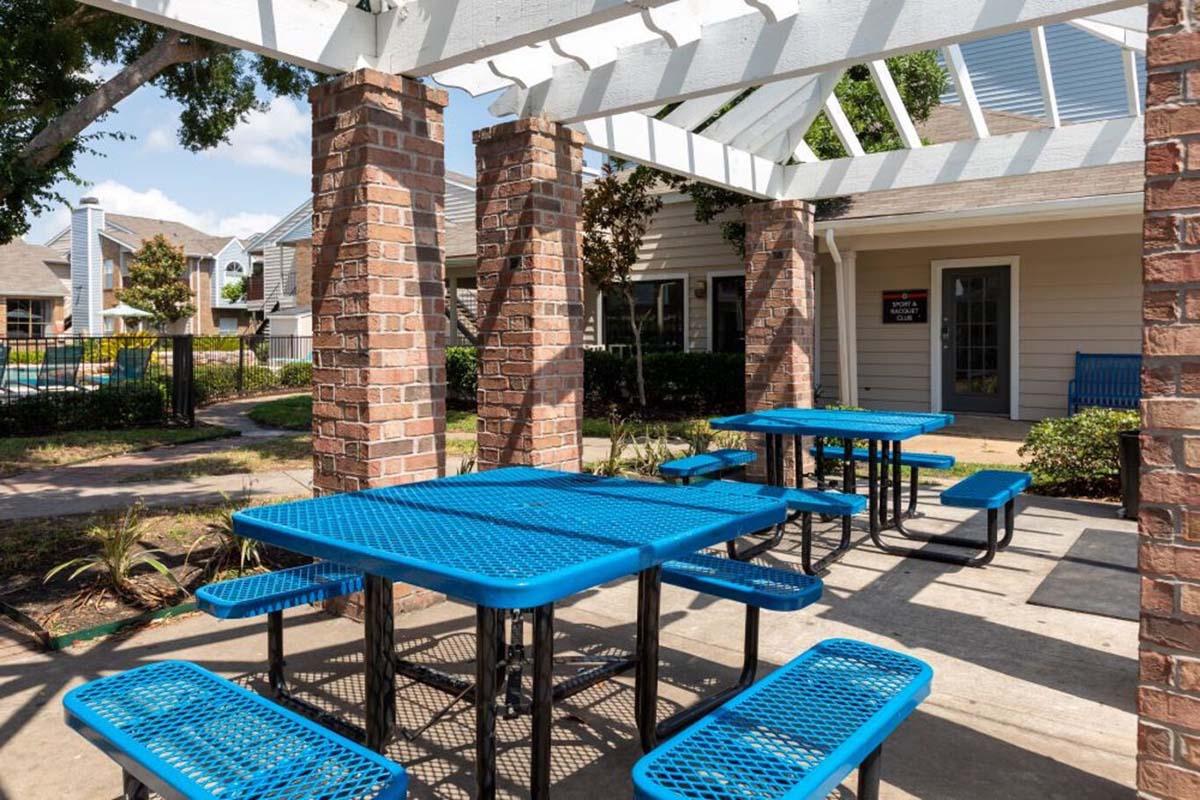 a blue bench in front of a brick building