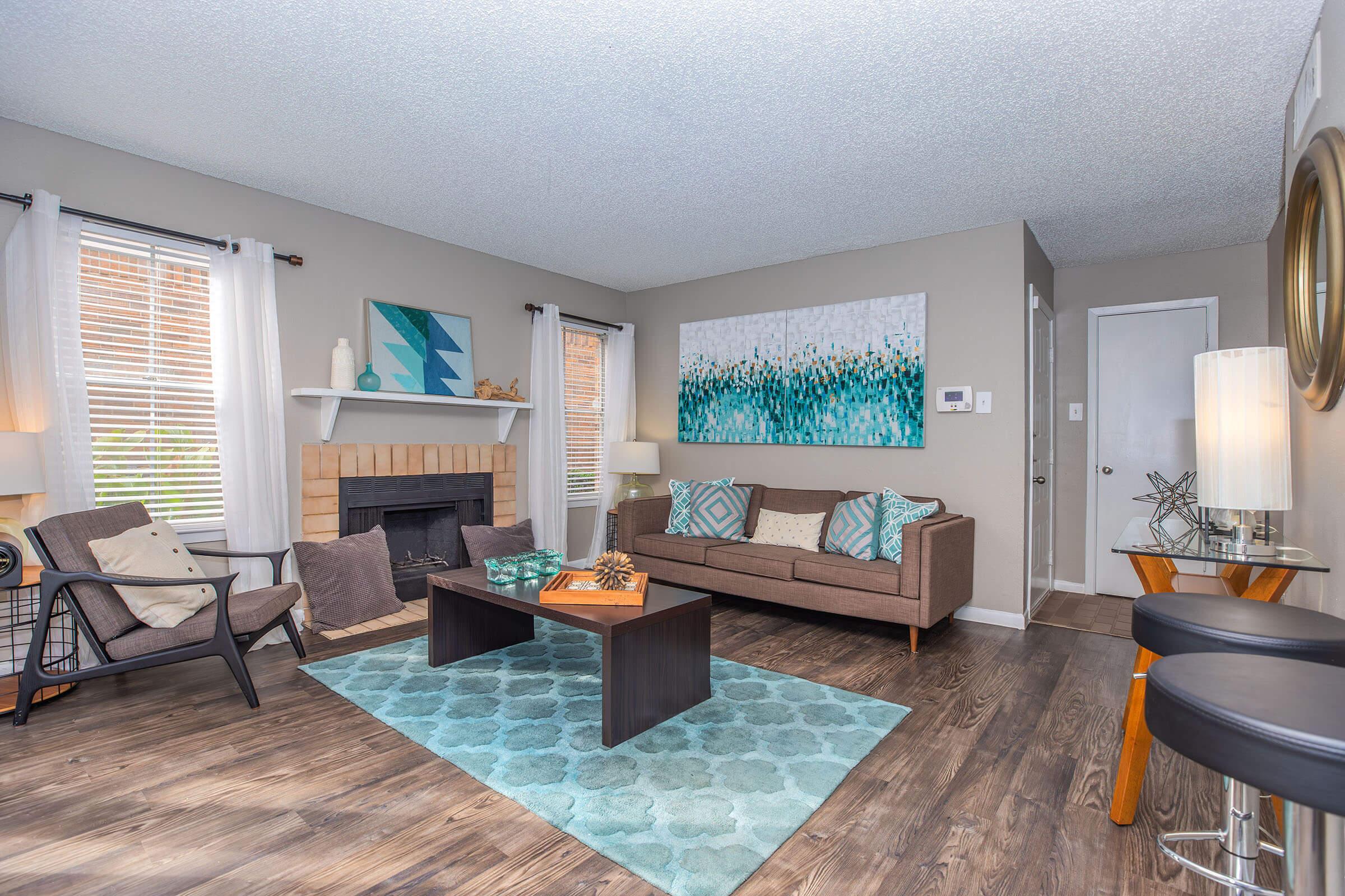 a living room filled with furniture and a large window