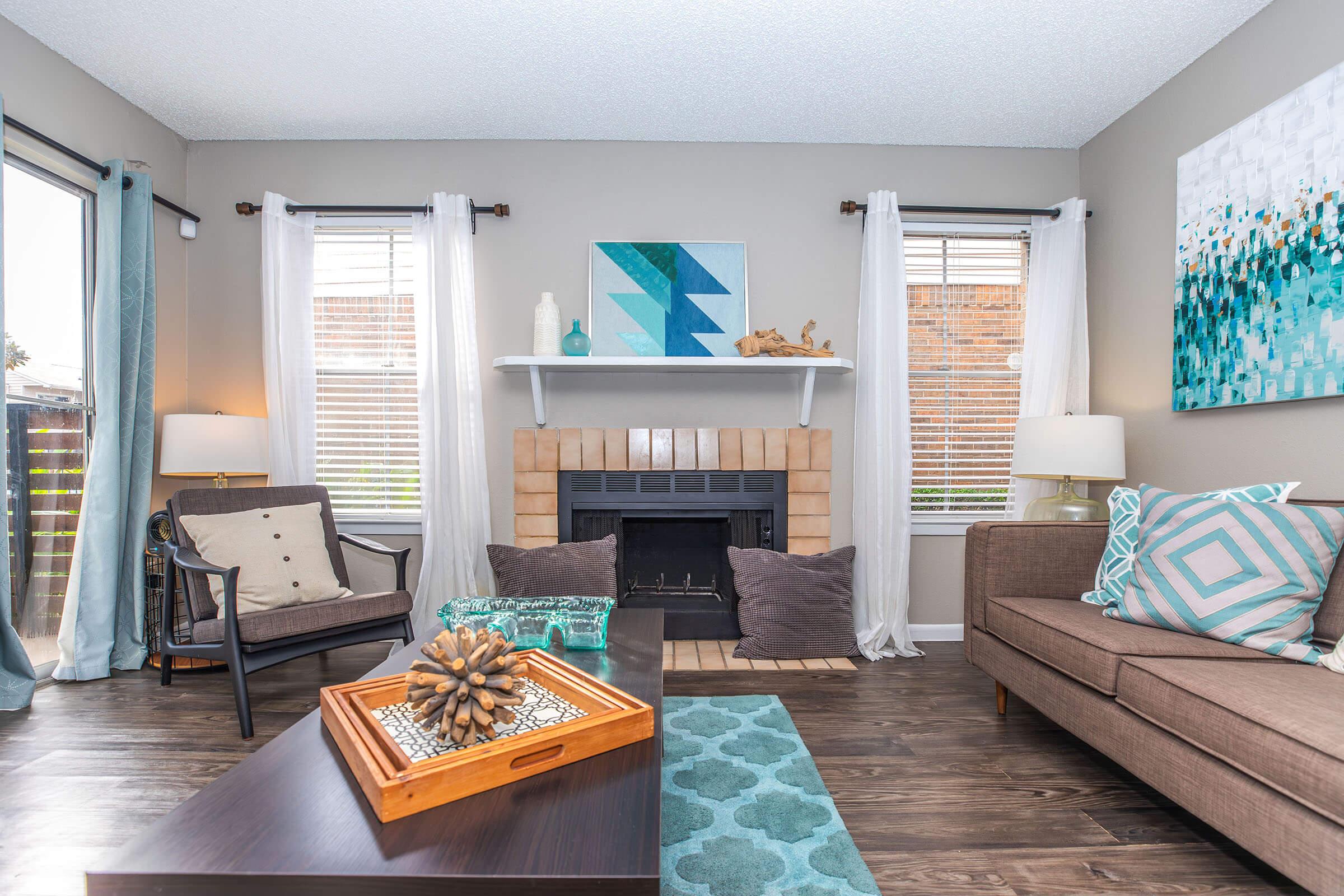 a living room filled with furniture and a large window