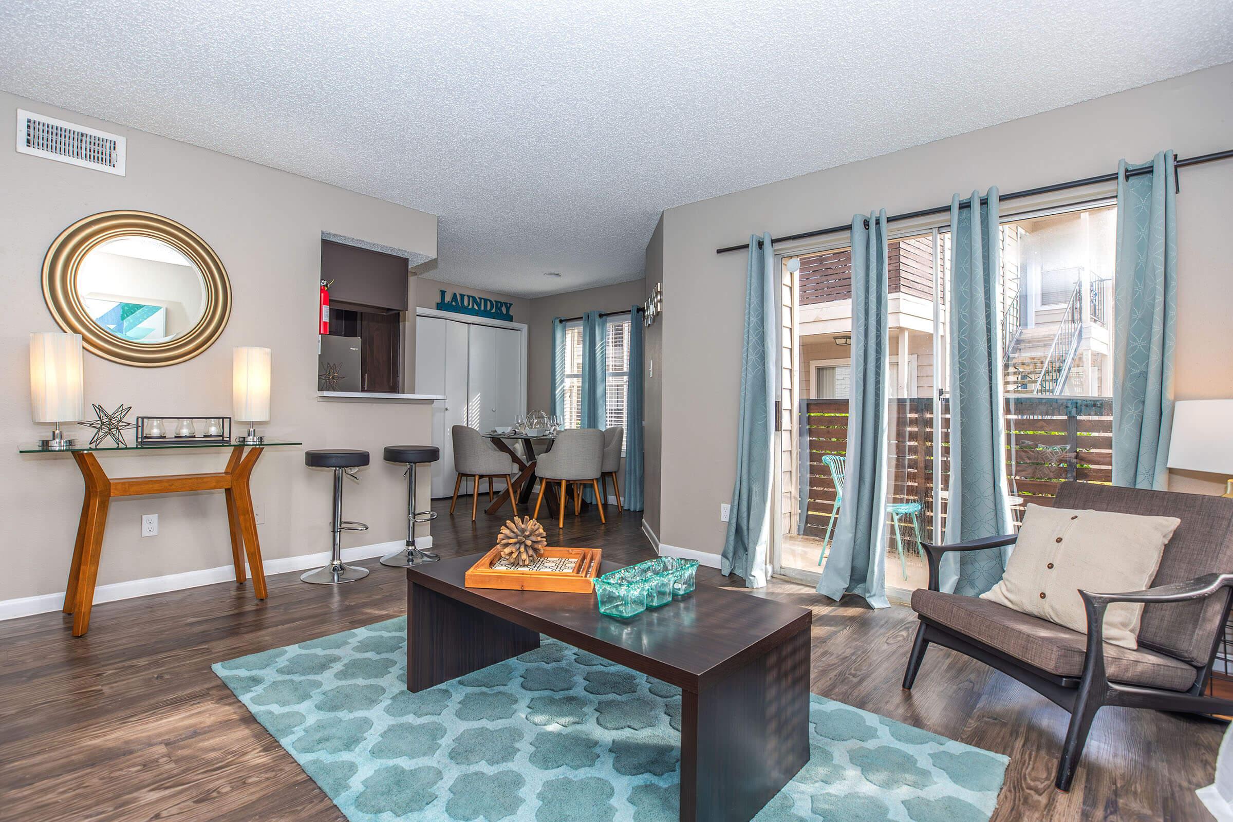 a living room filled with furniture and a large window