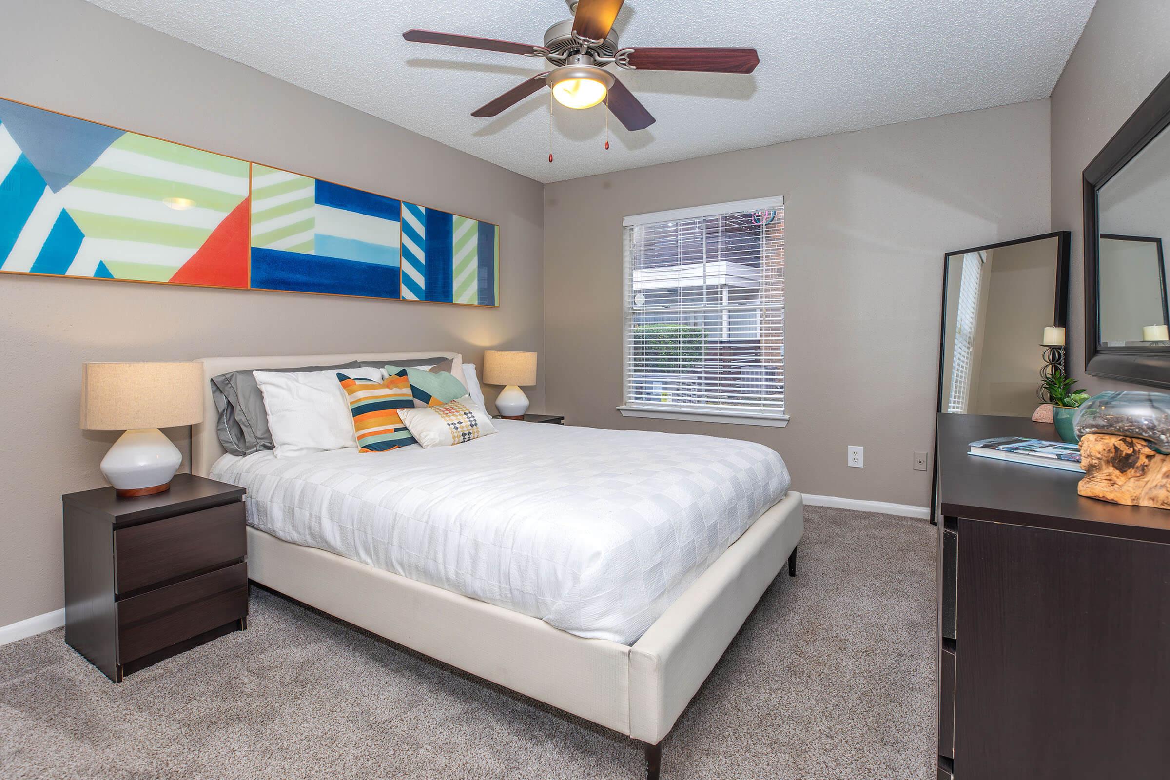 a bedroom with a bed and desk in a small room