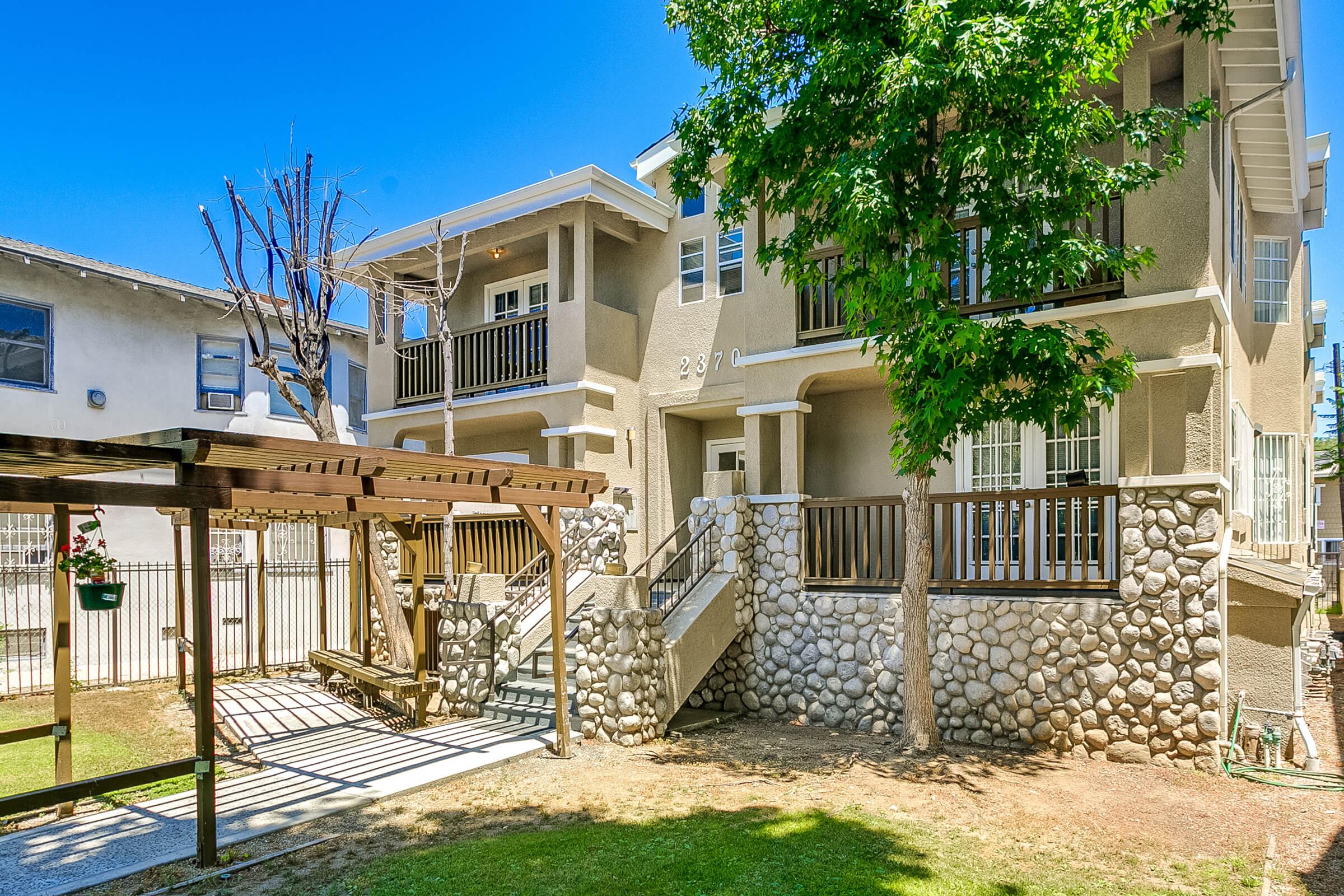 a house with a fence in front of a building