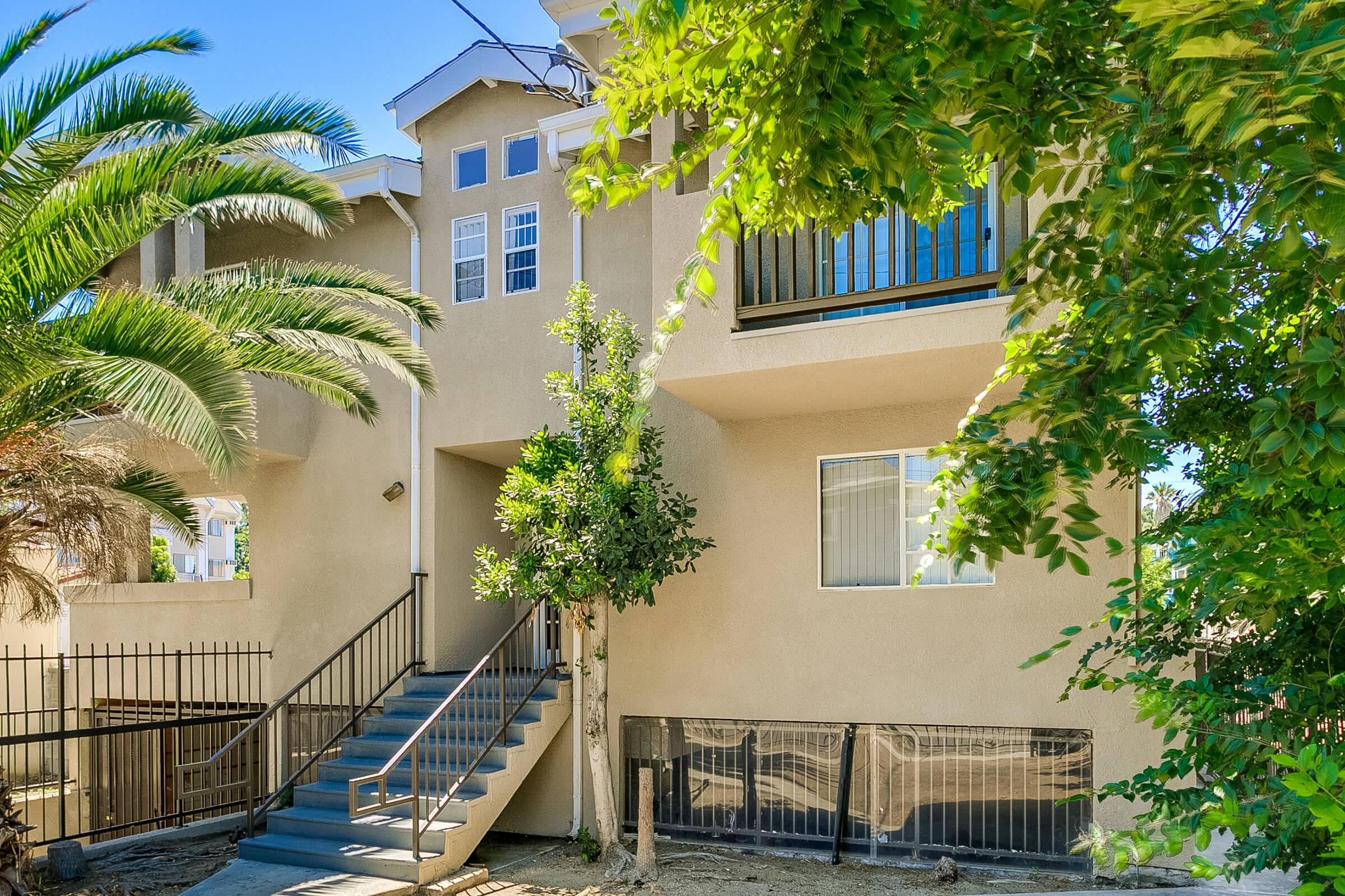 a house with bushes in front of a building