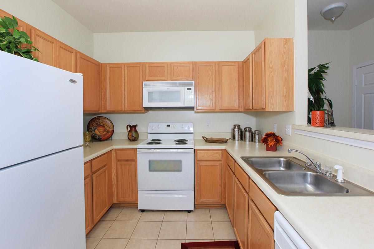 a kitchen with a white stove top oven sitting inside of a refrigerator