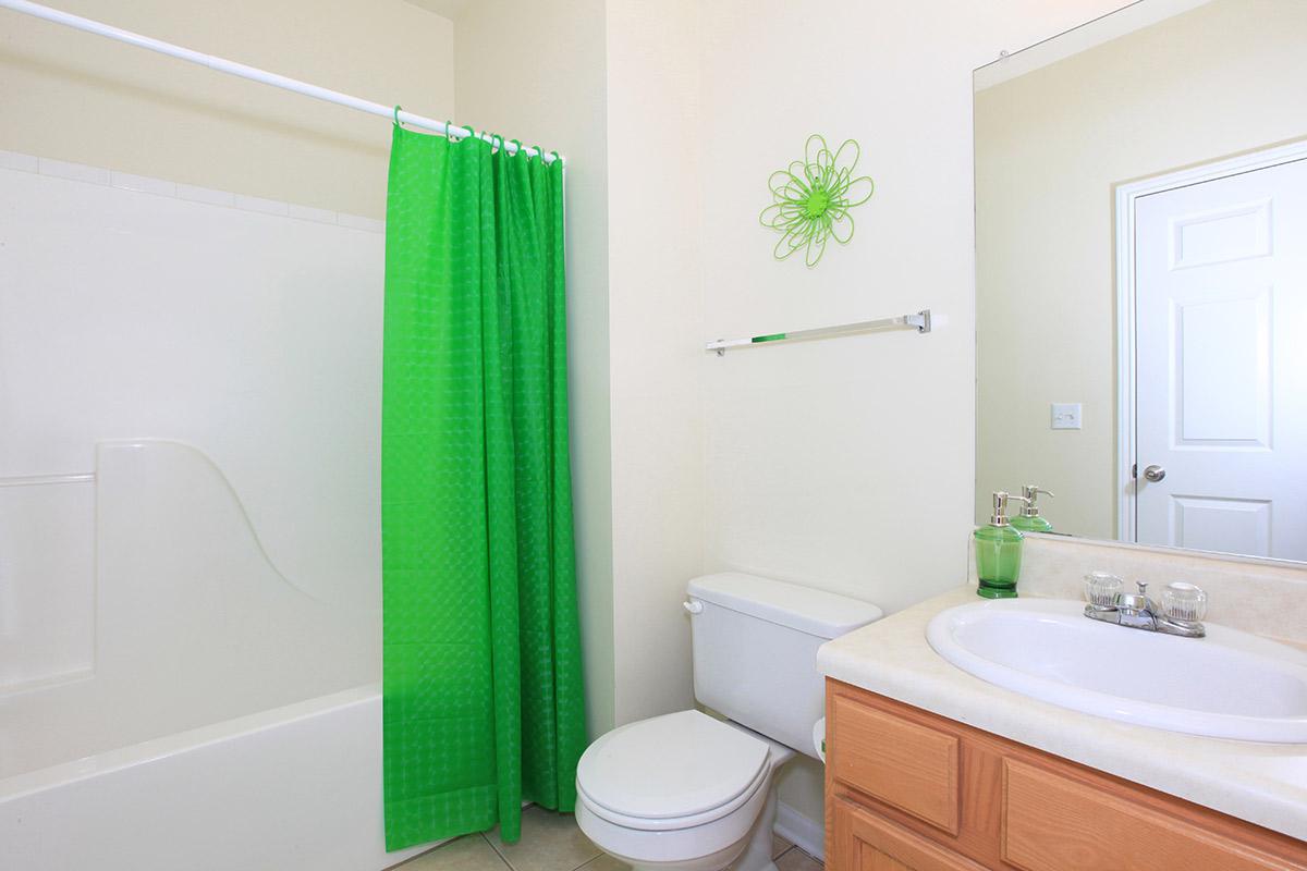 a white sink sitting next to a shower