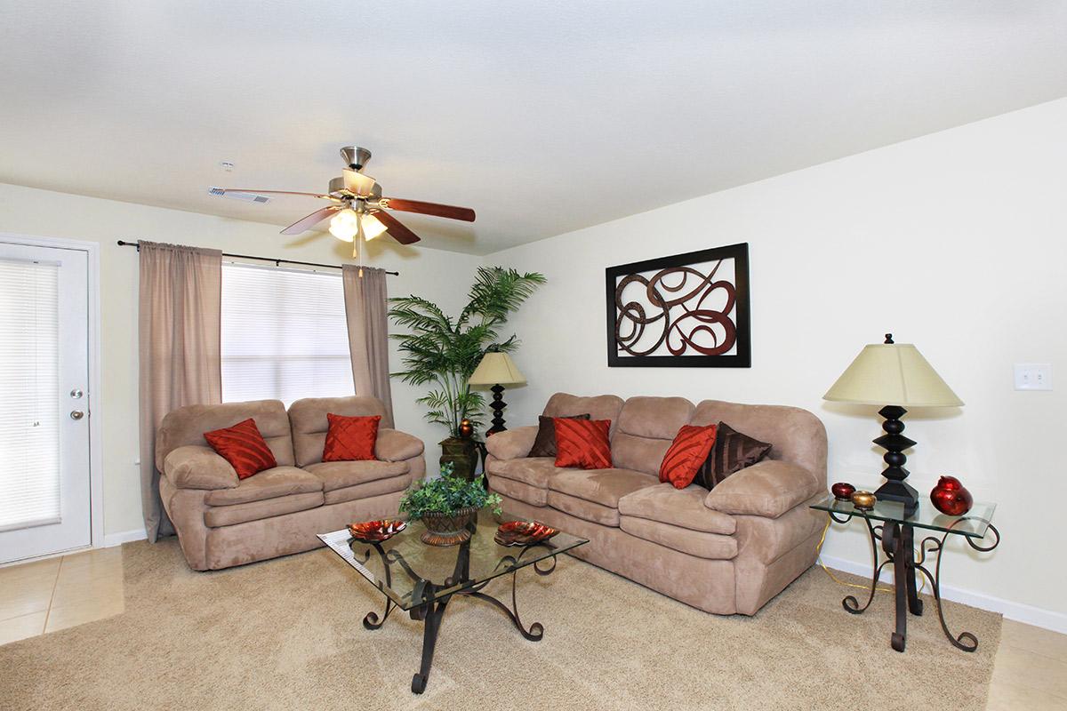 a living room filled with furniture and a flat screen tv