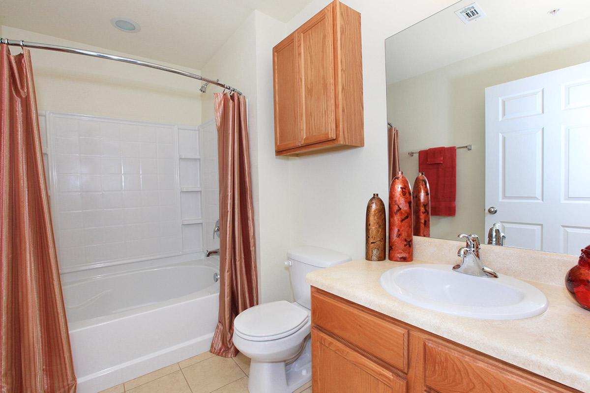 a white sink sitting next to a shower