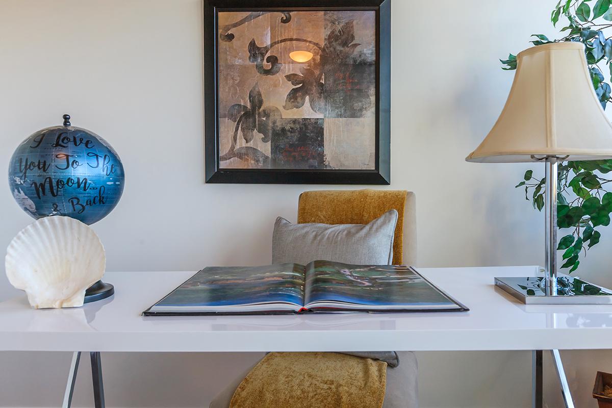 a room filled with furniture and vase of flowers on a table