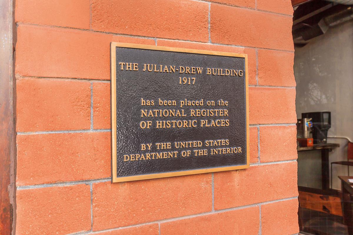 a sign on the side of a brick building