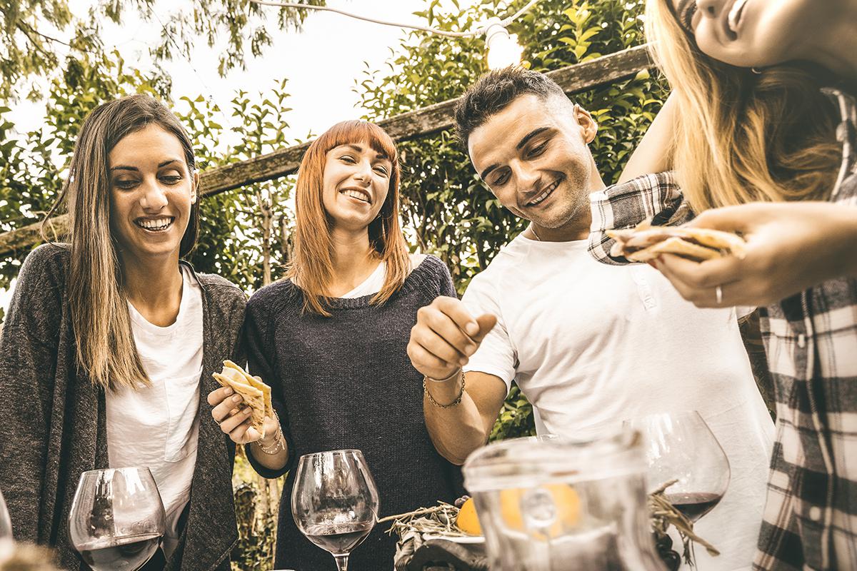 a couple of people are drinking from a wine glass