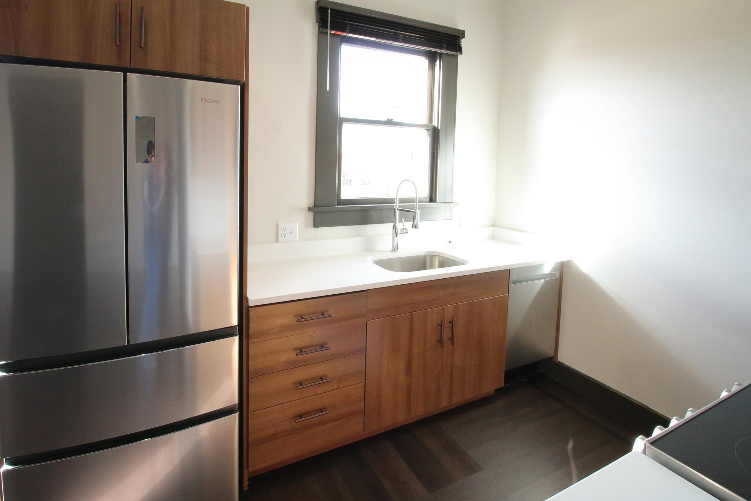 a refrigerator freezer sitting inside of a kitchen