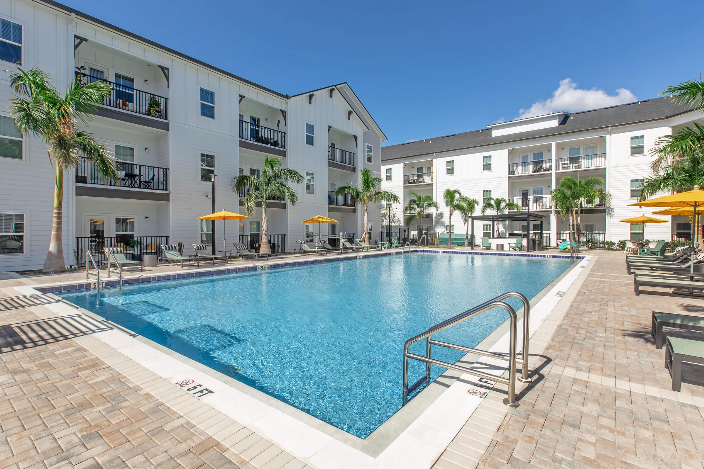 a house with a pool outside of a building