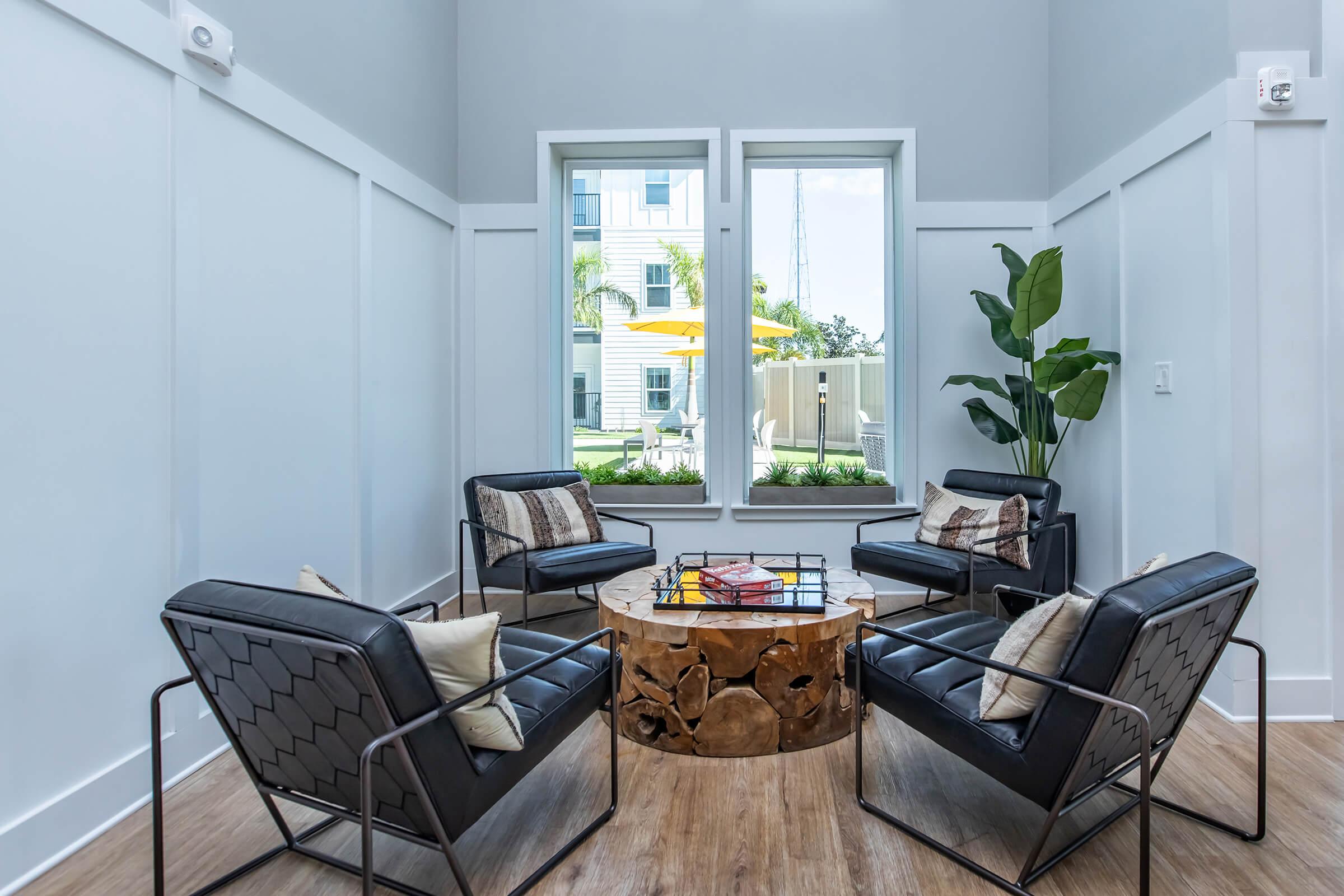 a living room filled with furniture and a large window