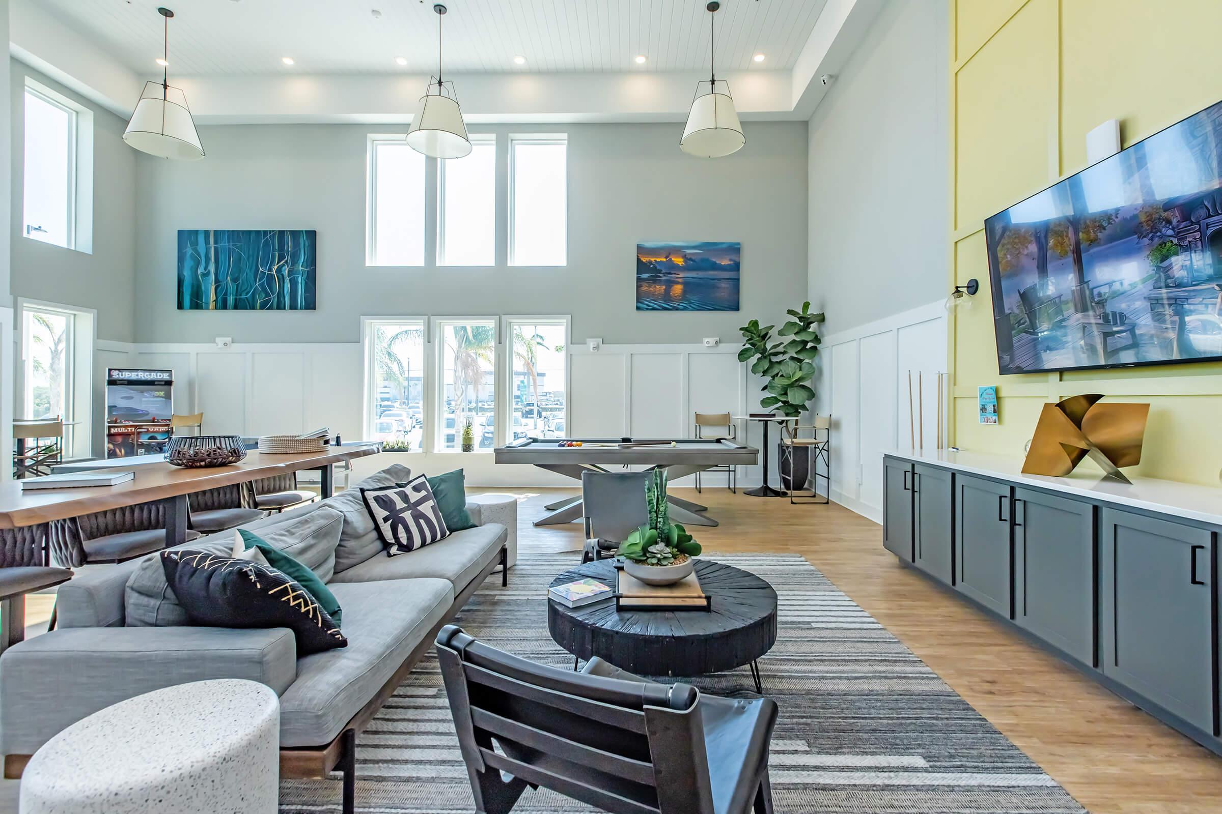 a living room filled with furniture and a large window