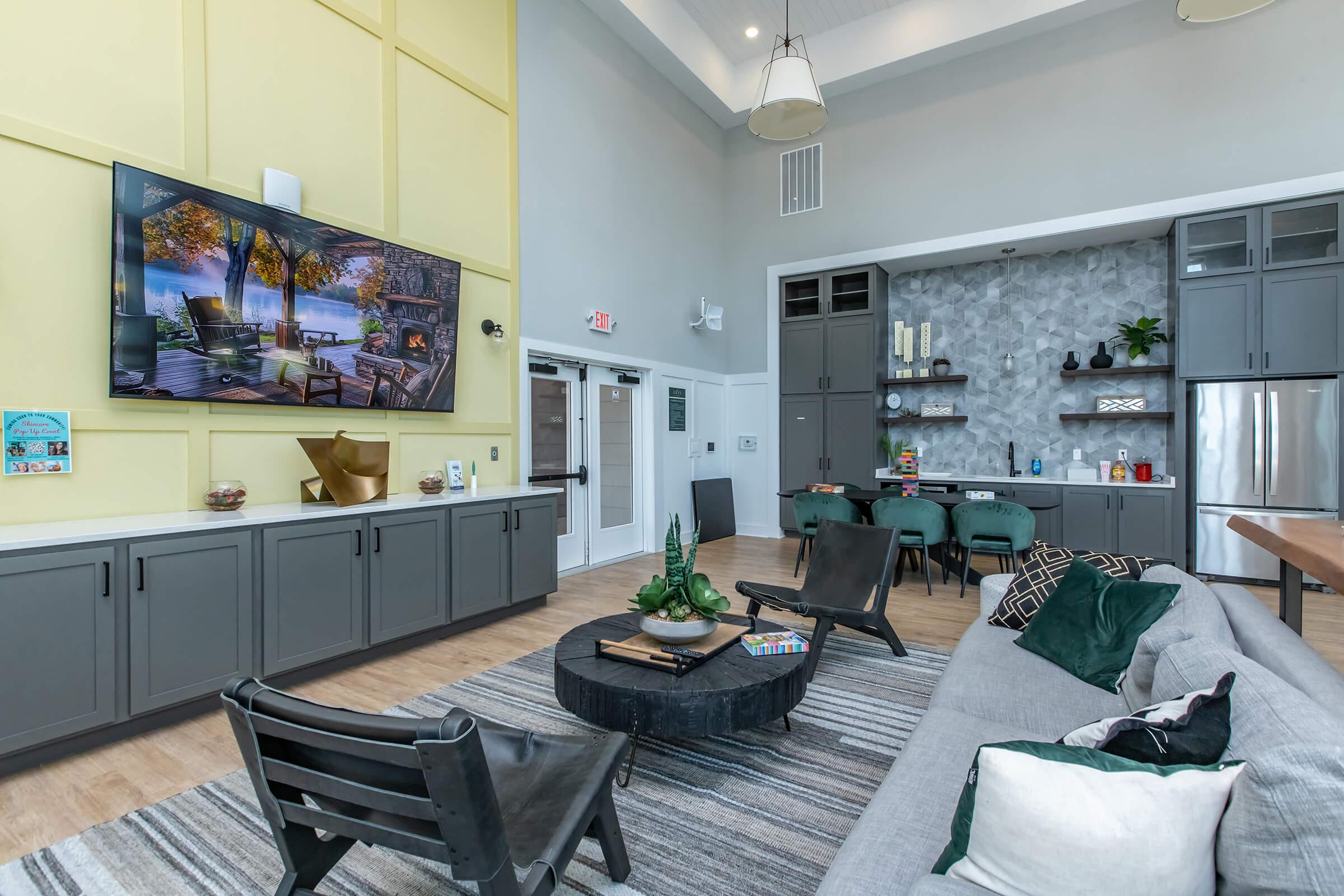 a living room filled with furniture and a flat screen tv