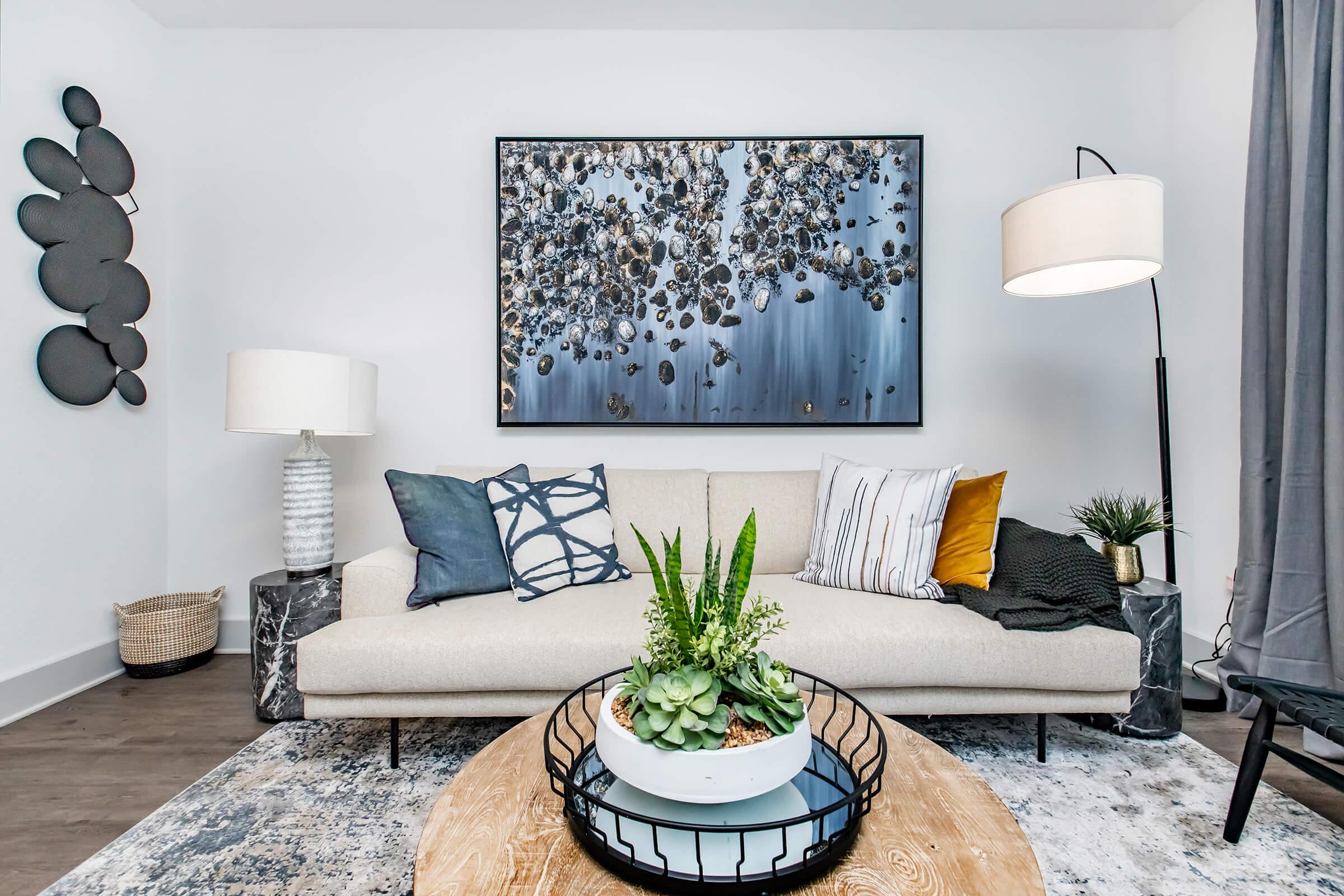 a living room filled with furniture and vase of flowers on a table