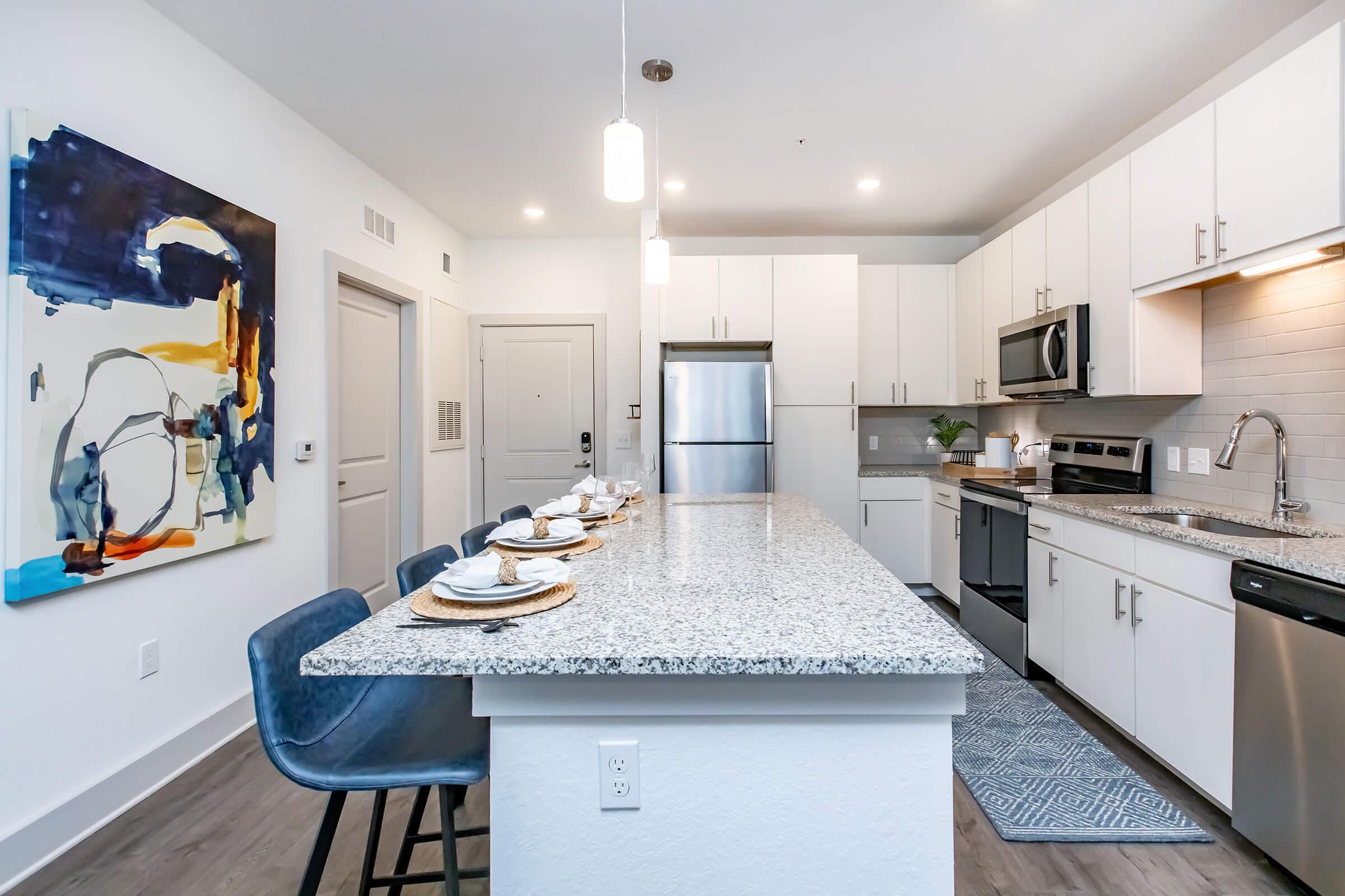 a kitchen with an island in the middle of a room