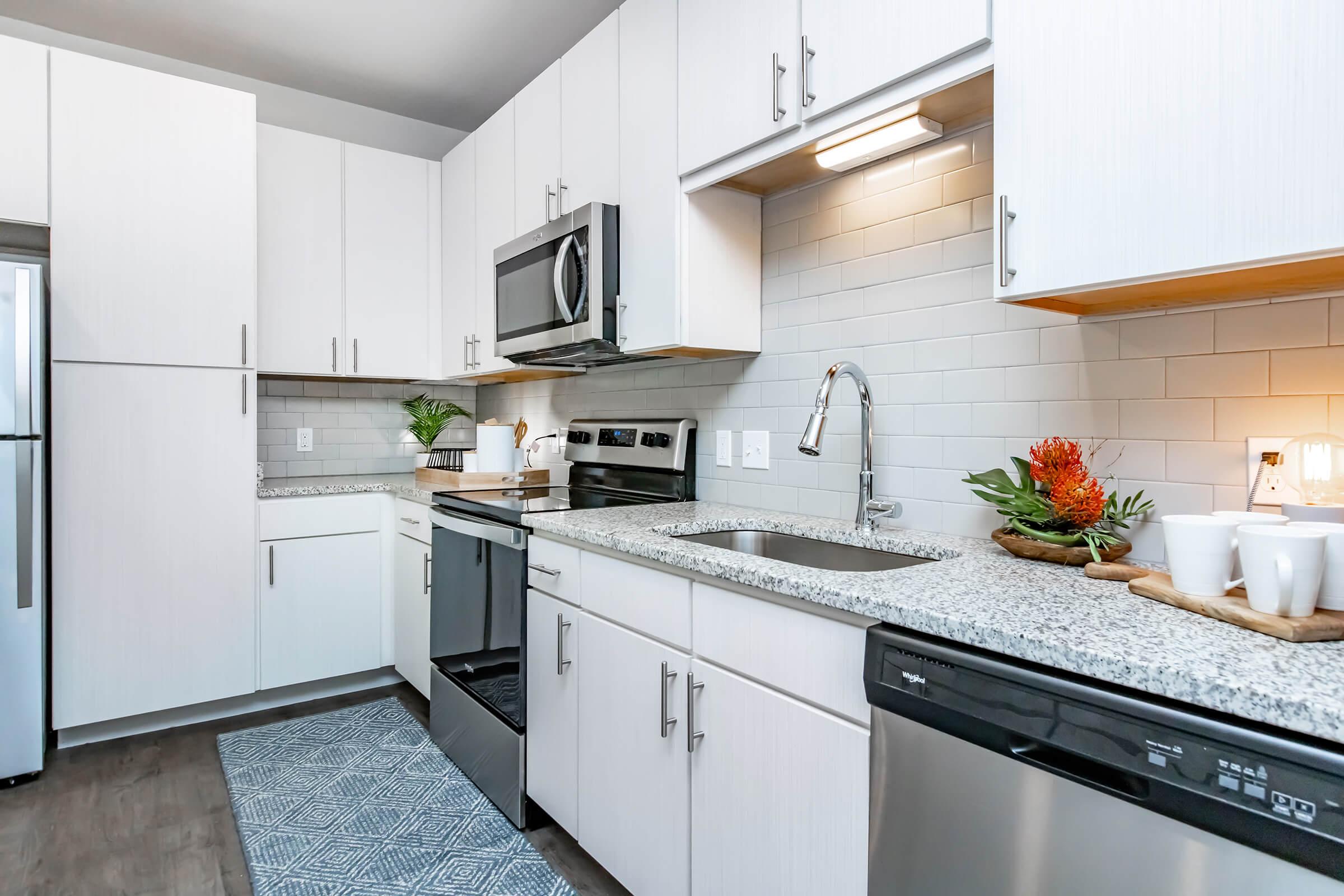 a kitchen with a stove sink and refrigerator